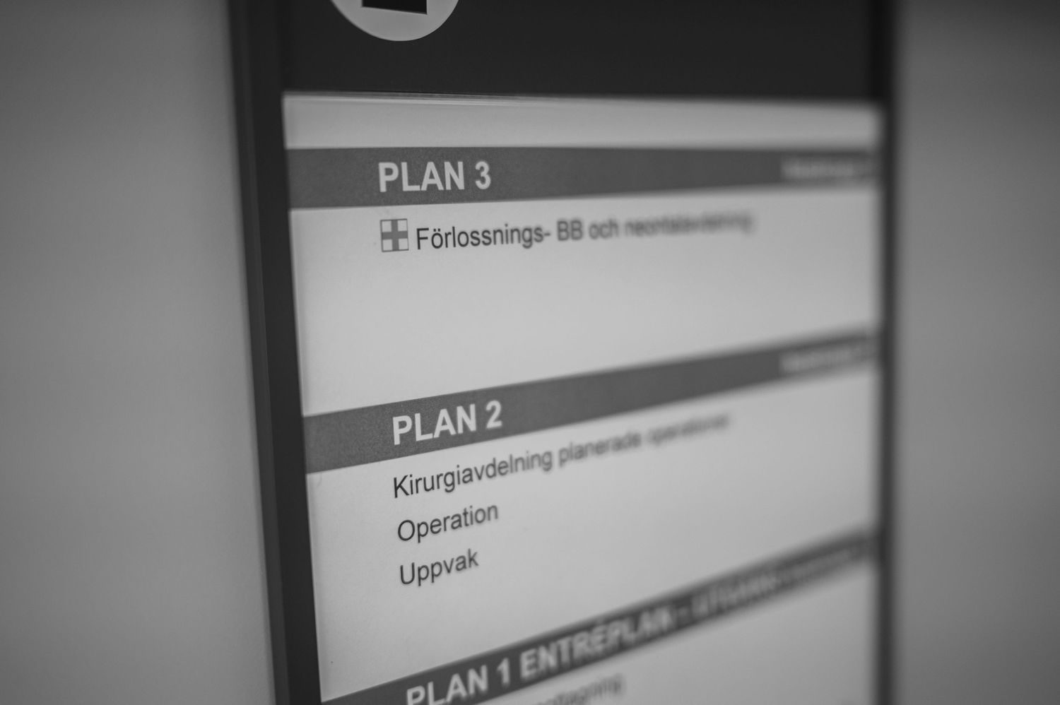 Close-up view of a list showing plan numbers and text on a screen or display in black and white.