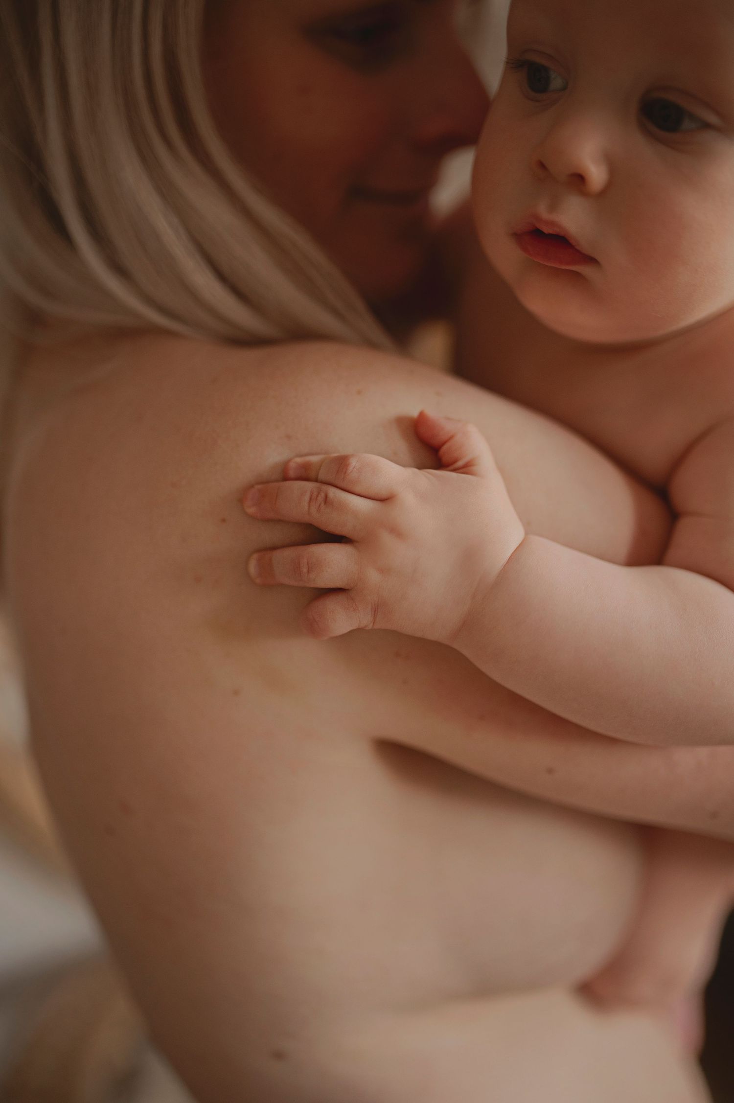 Close-up portrait showing tender interaction and gentle touch.