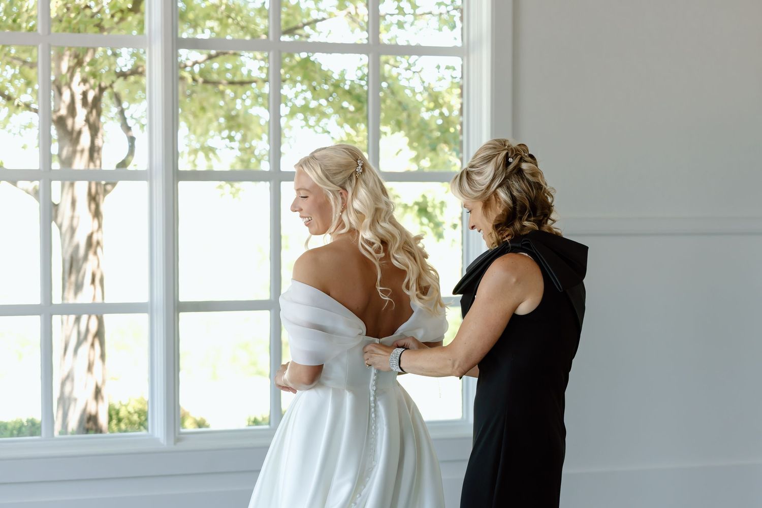 Mother of the bride helps the bride get ready at The Monroe wedding venue in West Des Moines, Iowa.