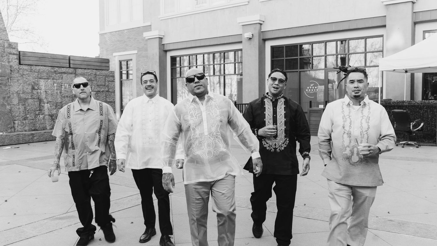 family birthday event Five men in barong tagalog traditional Filipino formal attire pose outdoors in a black and white photo.
