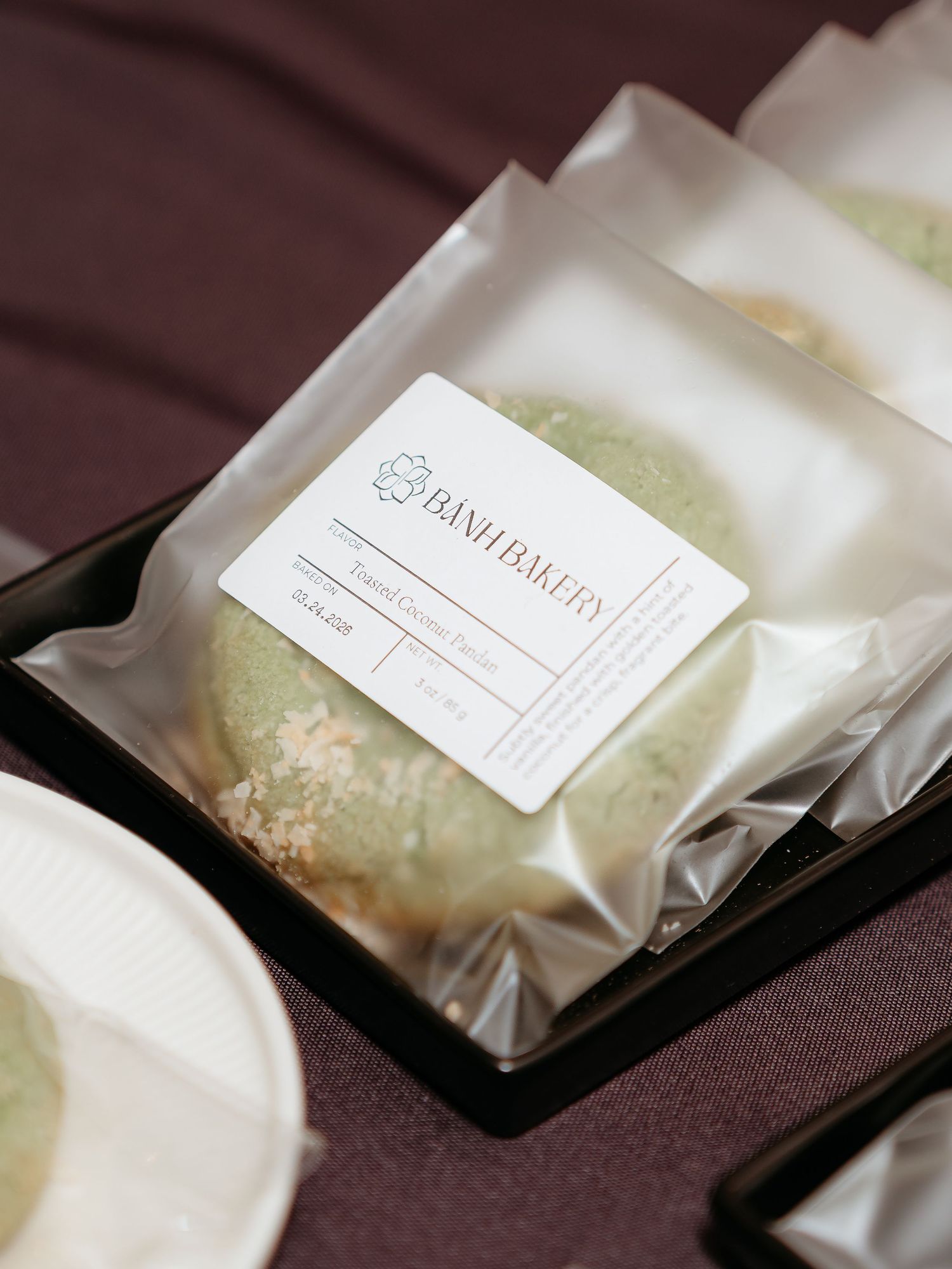 corporate event for tech company in tech industry Packaged green matcha mochi from Banh Bakery displayed on a black tray with a white label.