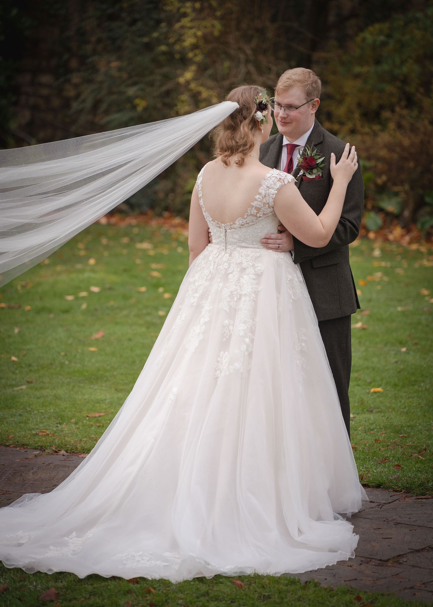Bride and groom looking at each other while posing together for the camera.