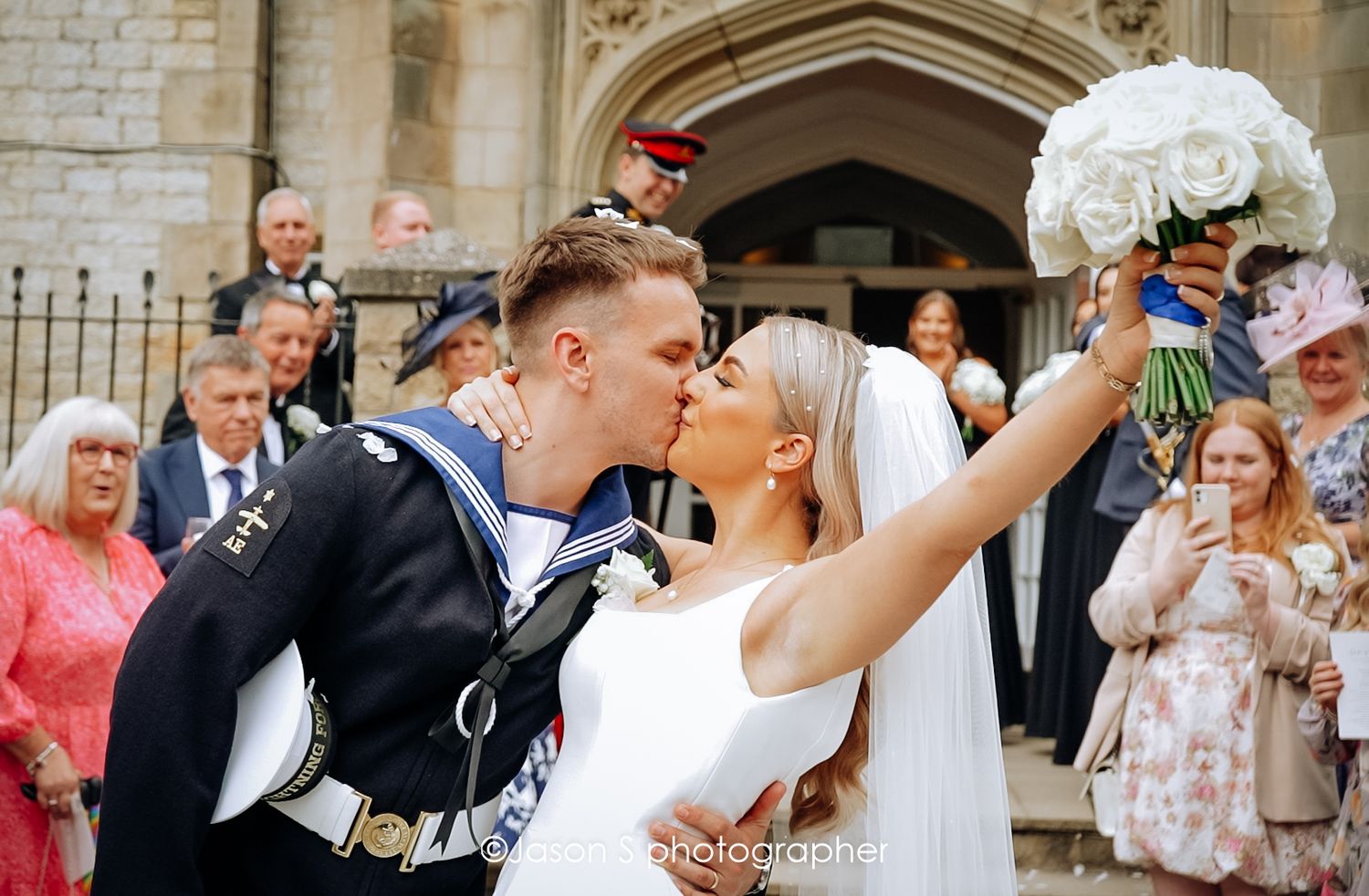 Bride and groom celebrate their marriage with a kiss.