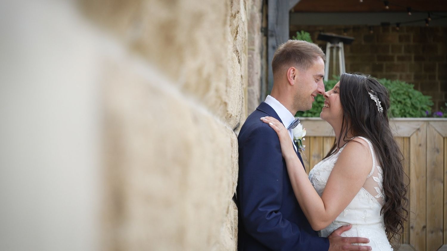 Bride and groom looking at each other while posing together for the camera.