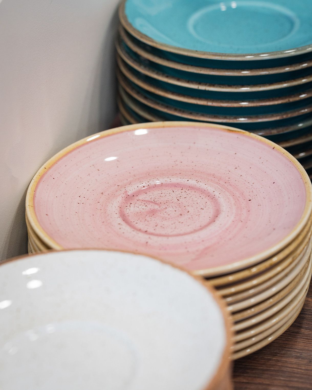 A close up of saucers stacked ready to be used in the  cinnammmm cafe