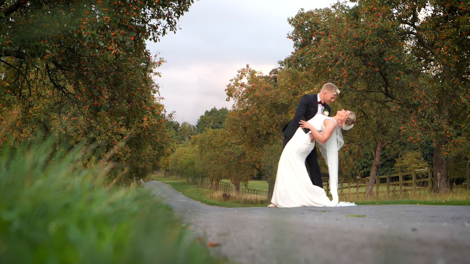 Bride and groom sharing a dipped kiss together.