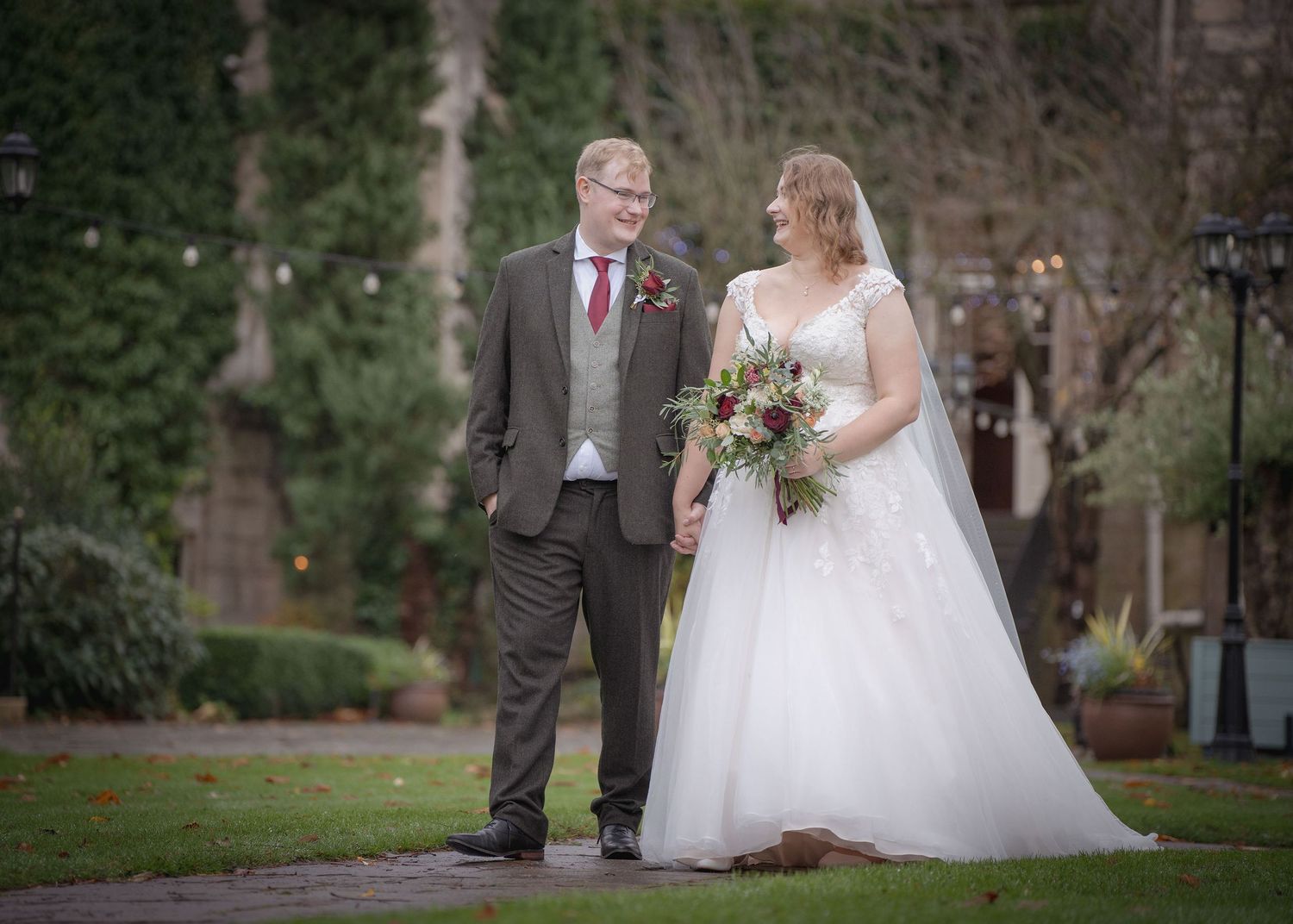 Bride and groom looking at each other while posing together for the camera.