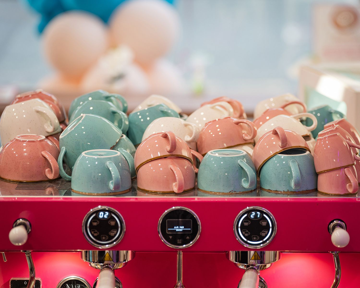 Close-up of cups on top of the coffee machine at cinnammmm cafe