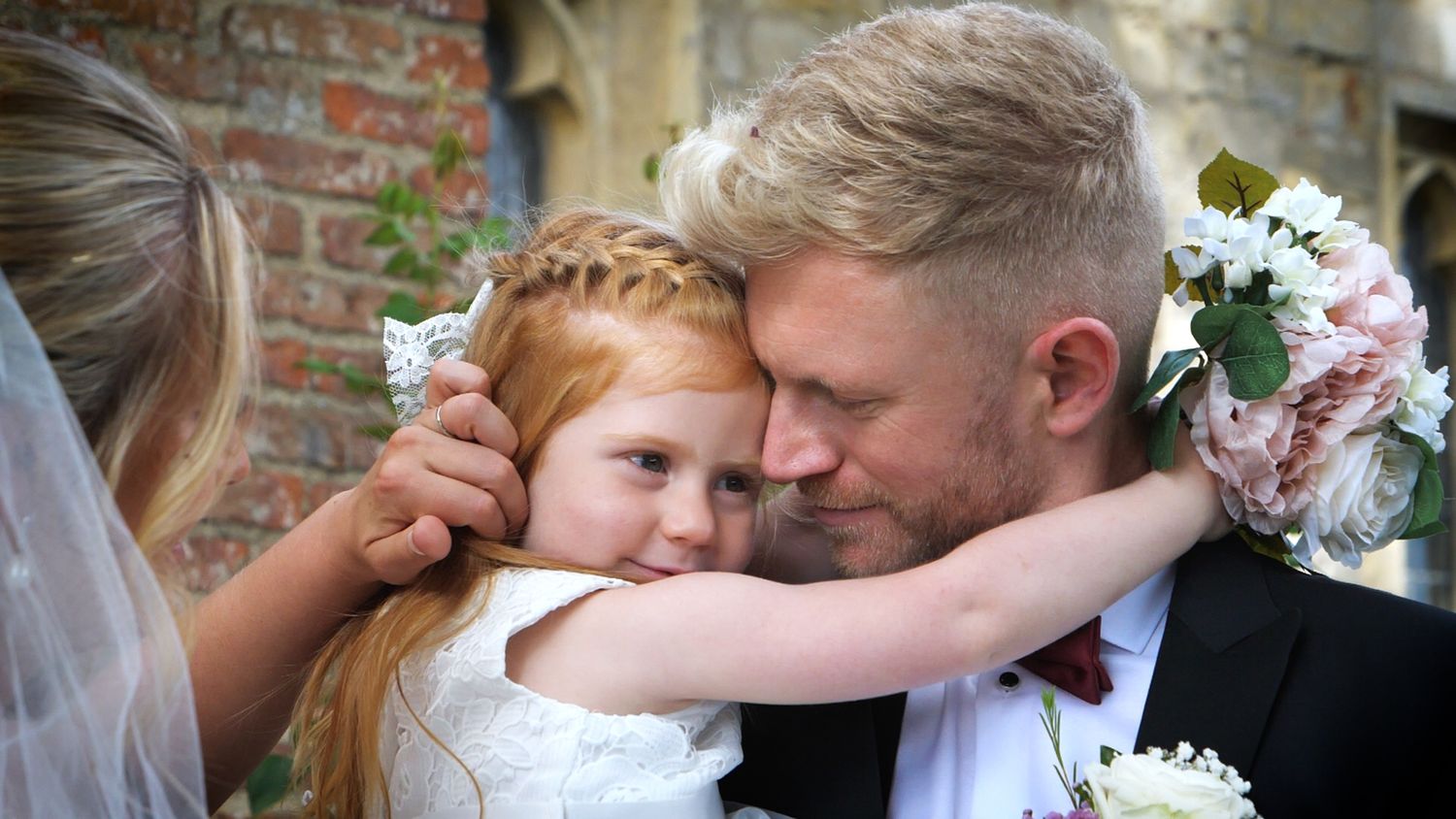 Groom hugging his daughter during the wedding day.