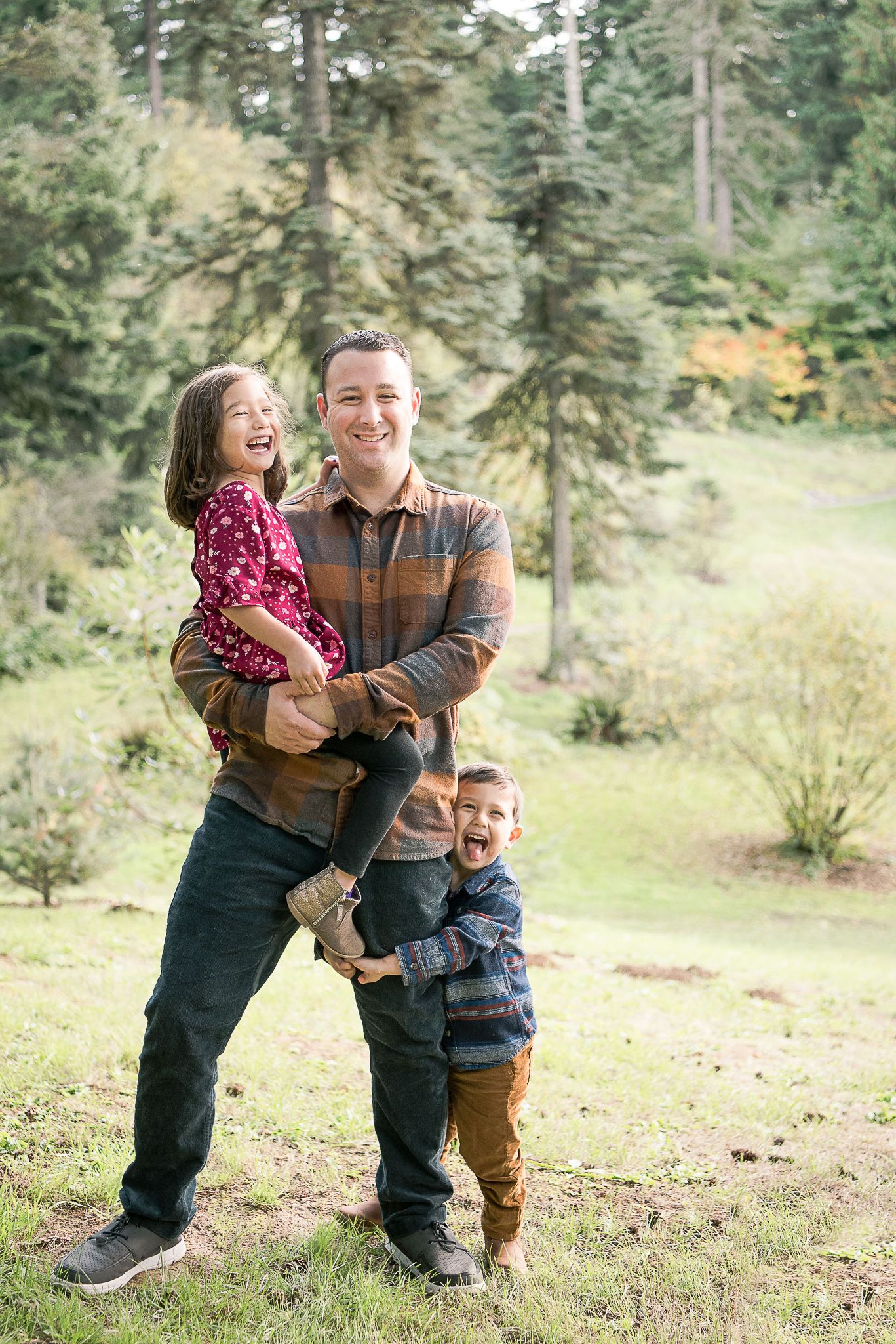 A playful family interaction captured in a scenic forest setting.