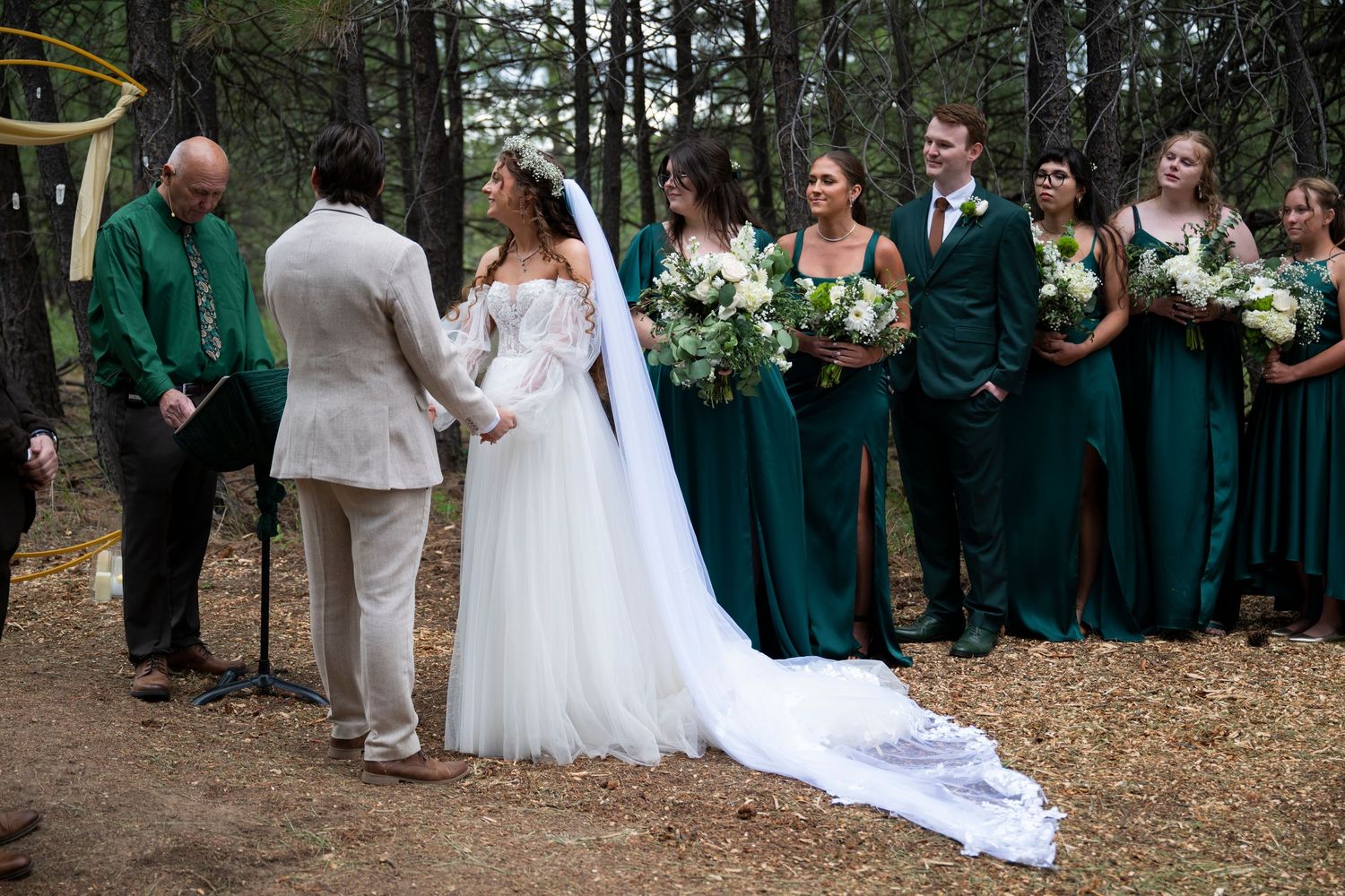 Bride and groom and bridesmaids looking at the officiant during a wedding ceremony in the dalles, oregon