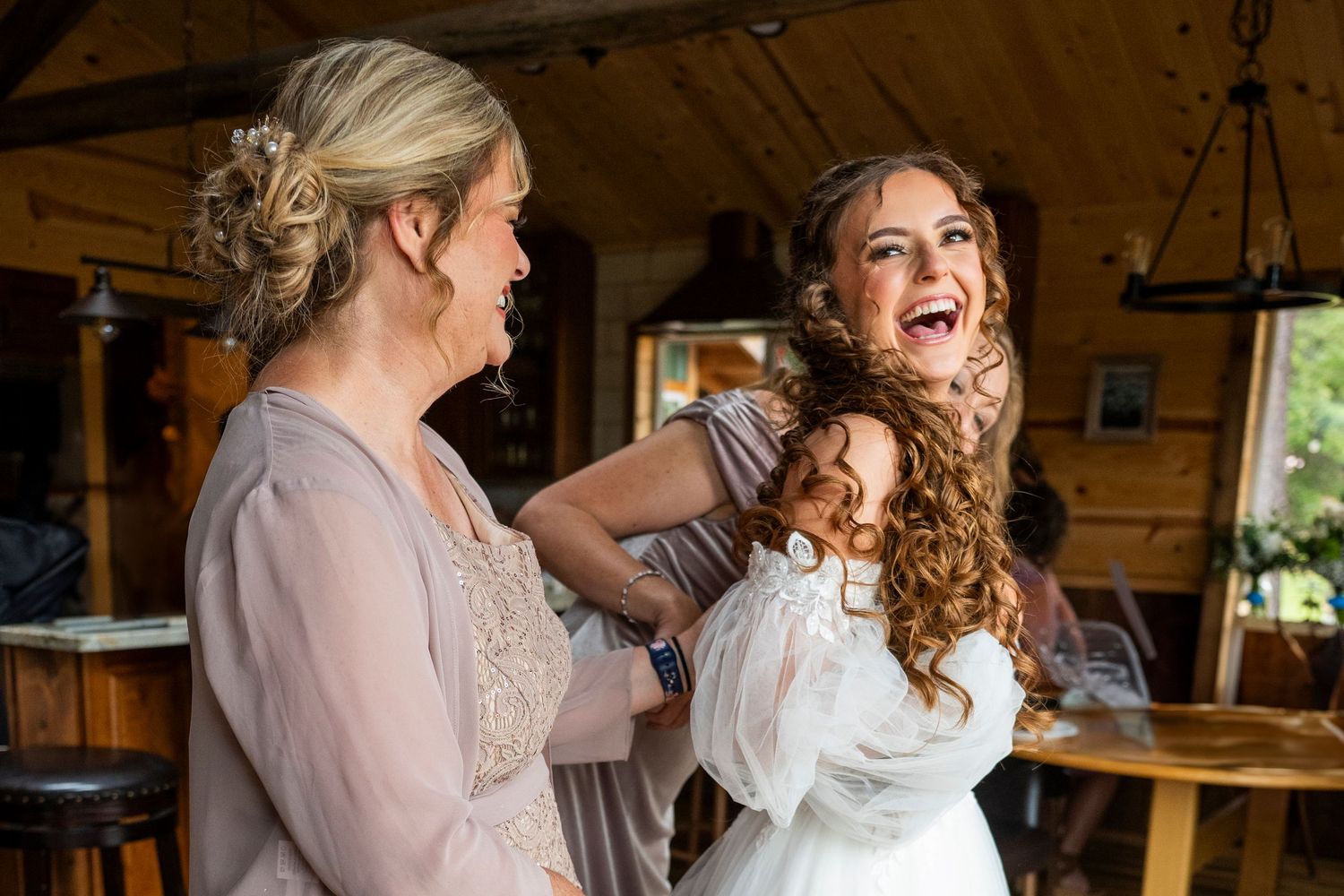 Joyful celebration moments captured in a rustic barn setting with string lights.