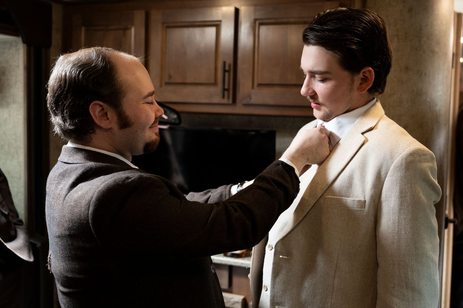 Best man straightens an oregon groom's tie