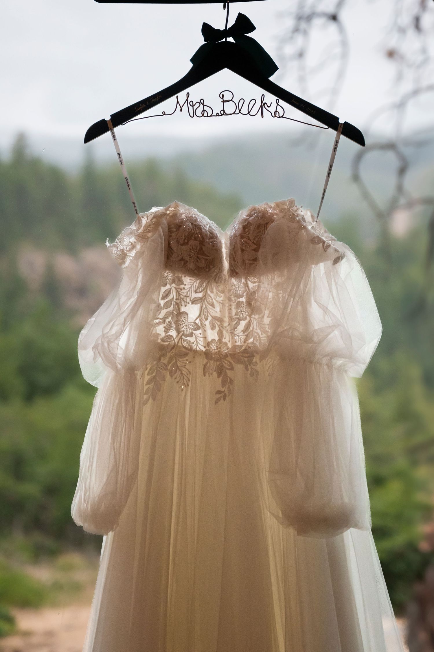 An Oregon brides dress hands in a window in the The Dalles