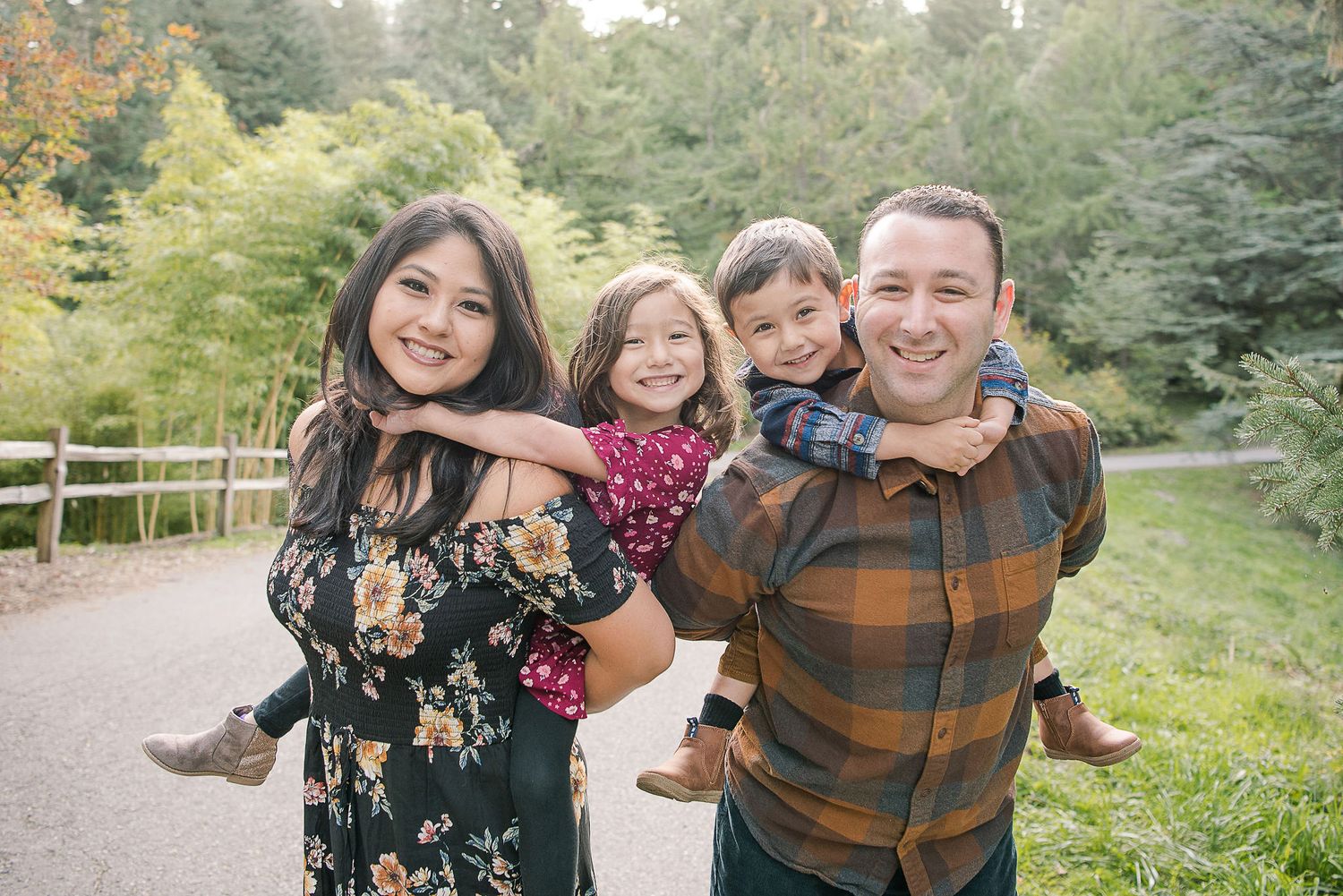 A family shares joyful moments together during an outdoor photography session.