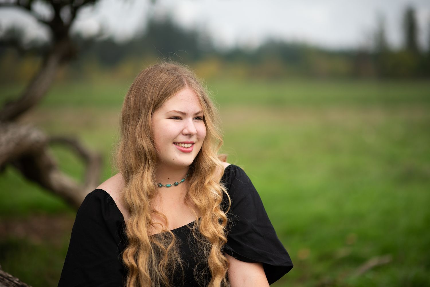 A portrait in a rustic field setting with soft natural lighting and autumn colors.