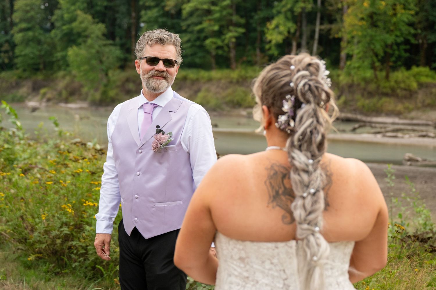A couple shares a romantic moment in a natural outdoor setting.