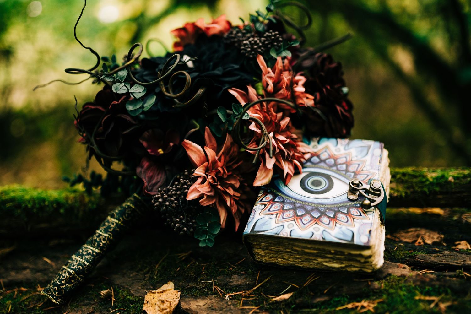 A vintage cassette tape lies among autumn leaves on mossy ground in a forest setting.