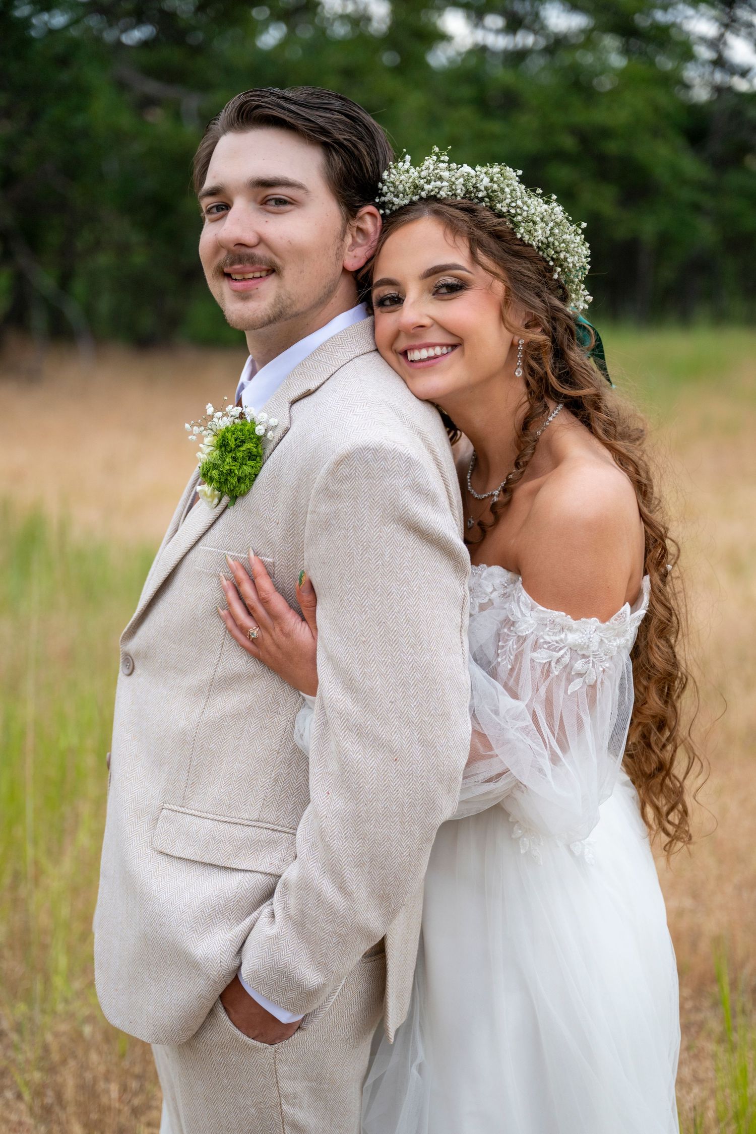 Bride and groom smile at the camera at their wedding in the dalles, oregon