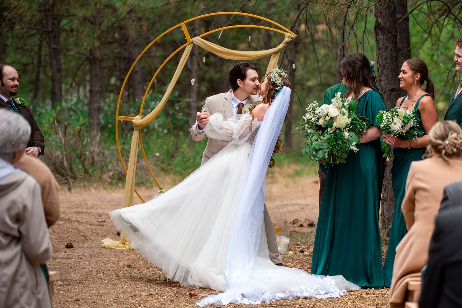 Groom dips bride for the first kiss during an oregon wedding ceremony