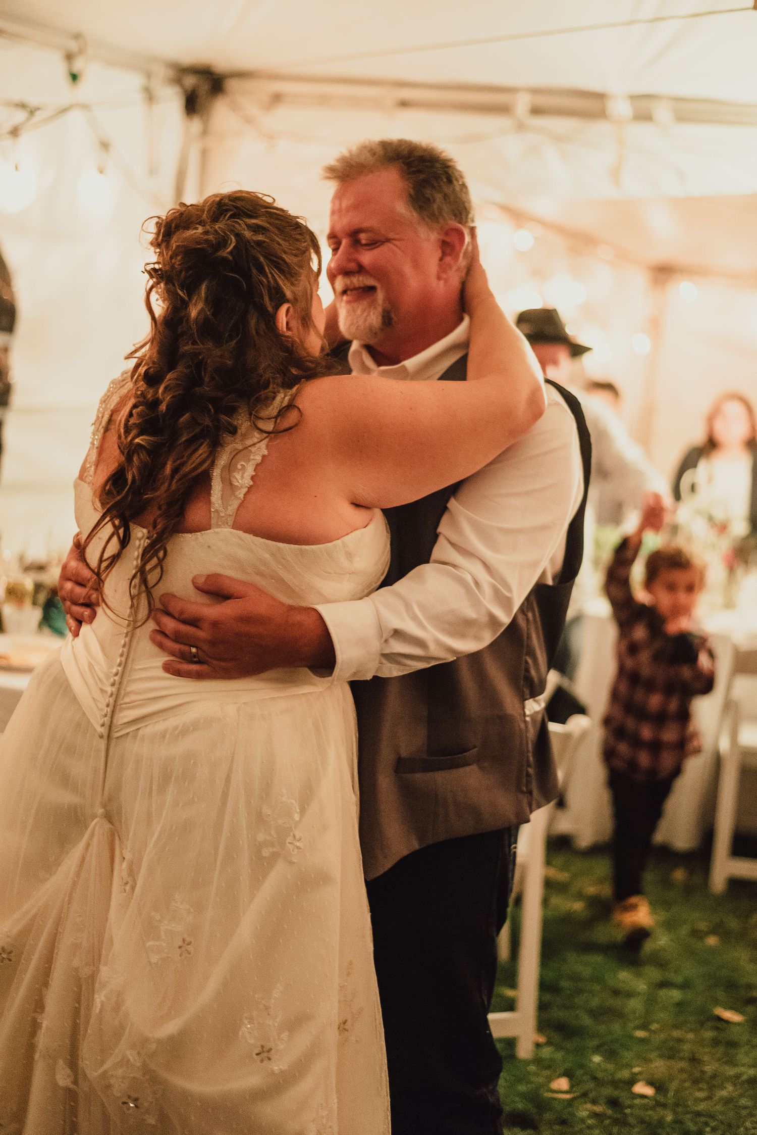Couples slow dancing together at a romantic wedding reception celebration.