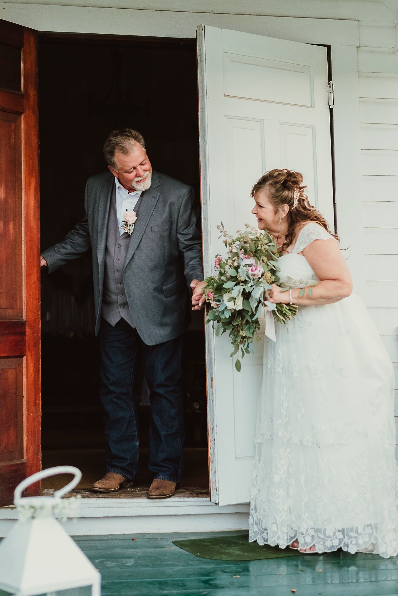 A wedding party moment captured at a white doorway entrance.