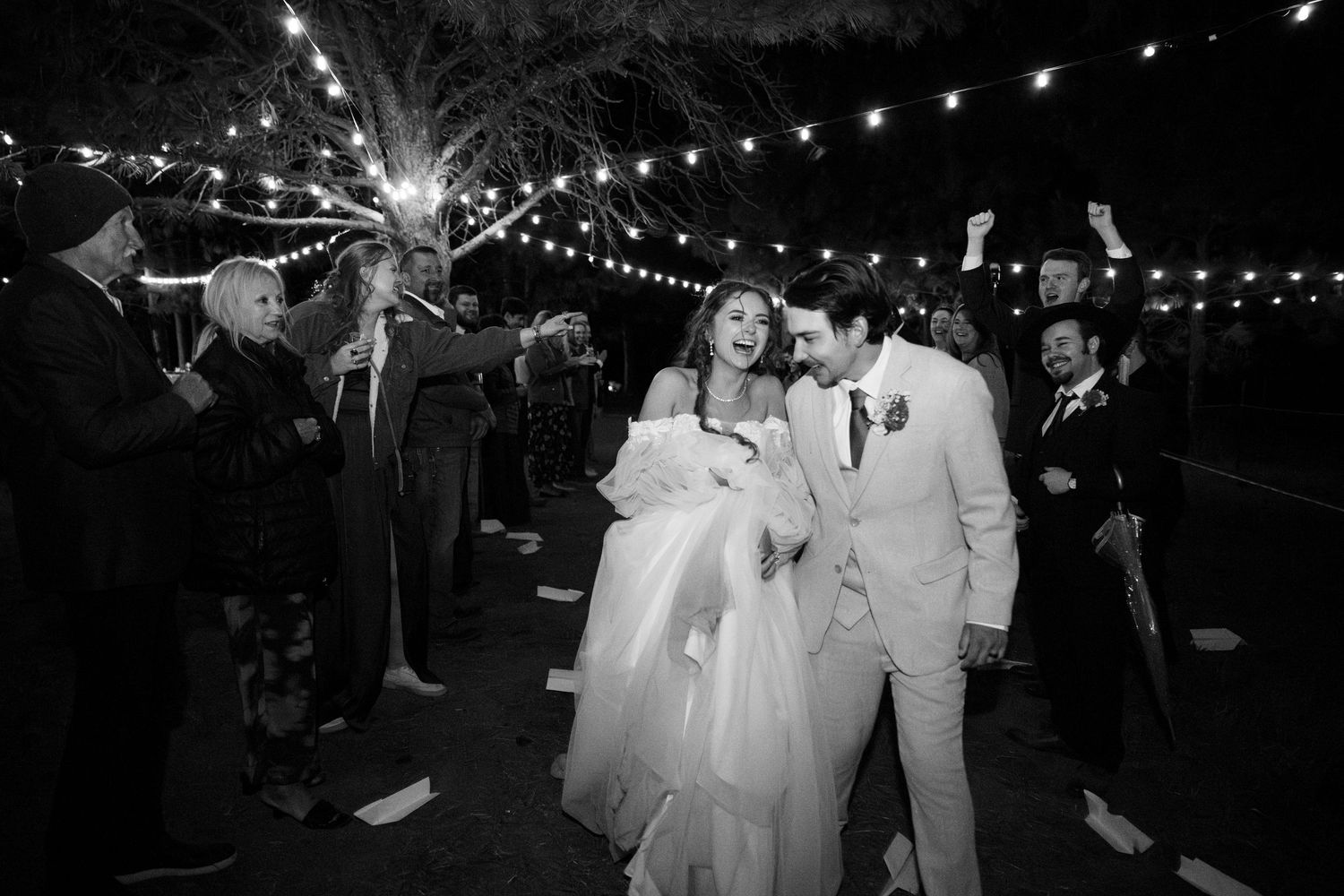 Bride and groom duck below paper airplanes during their special oregon wedding exit