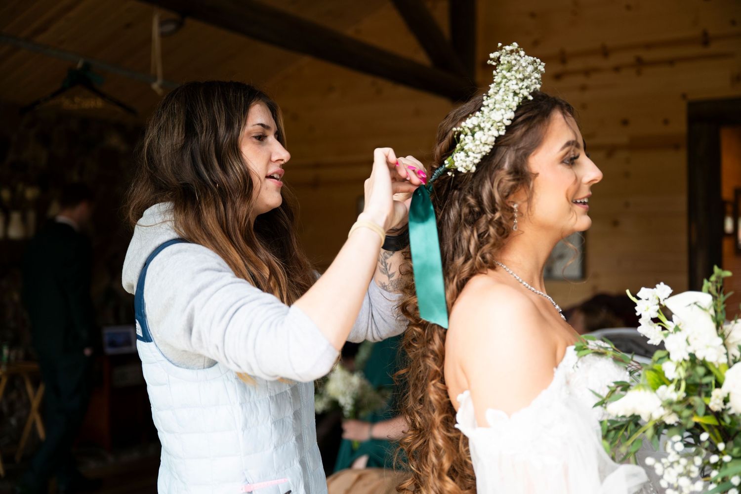 An oregon bride's hairdresser puts the finishing touches on her hair