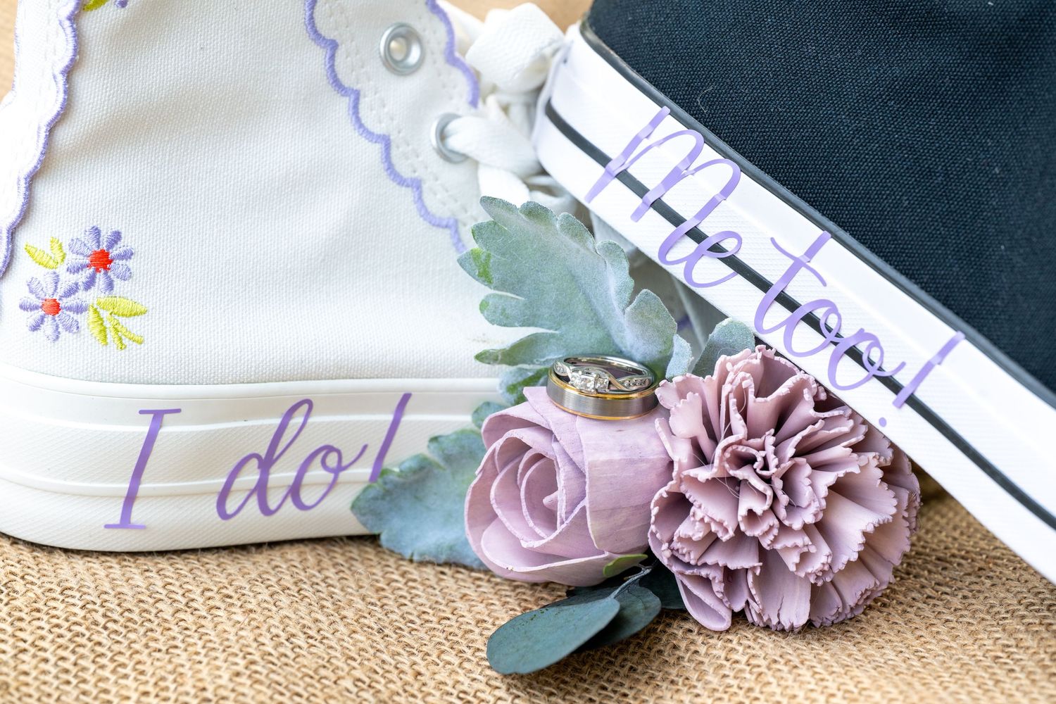 Wedding stationery and decorative elements arranged with pink carnations and eucalyptus.
