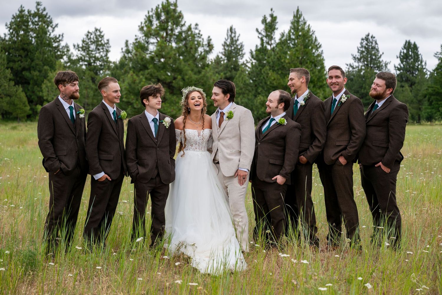 Bride laughs surrounded by groom and groomsmen at ranch wedding in the dalles, oregon