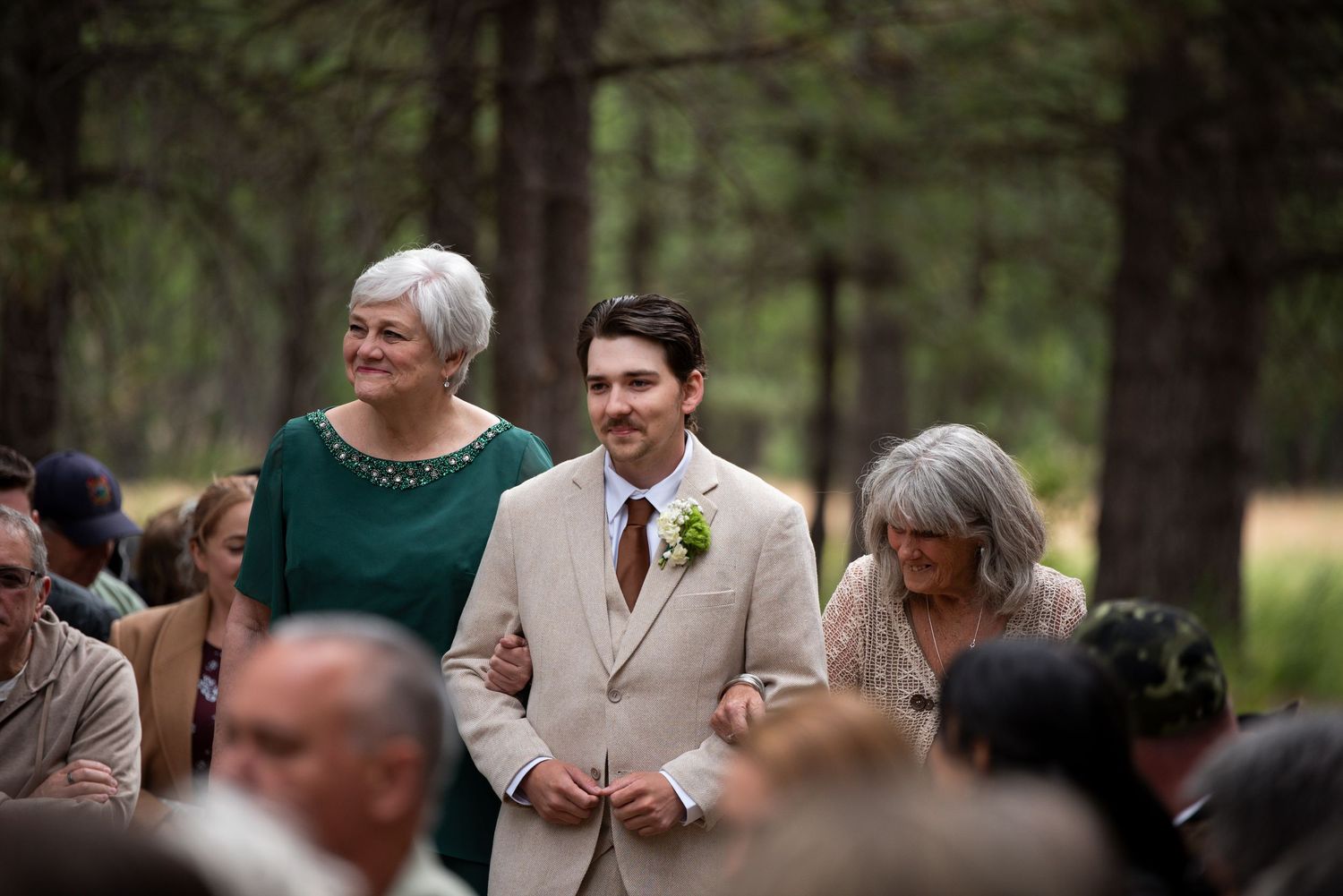 An oregon groom walks his grandmothers down the aisle to his wedding ceremony