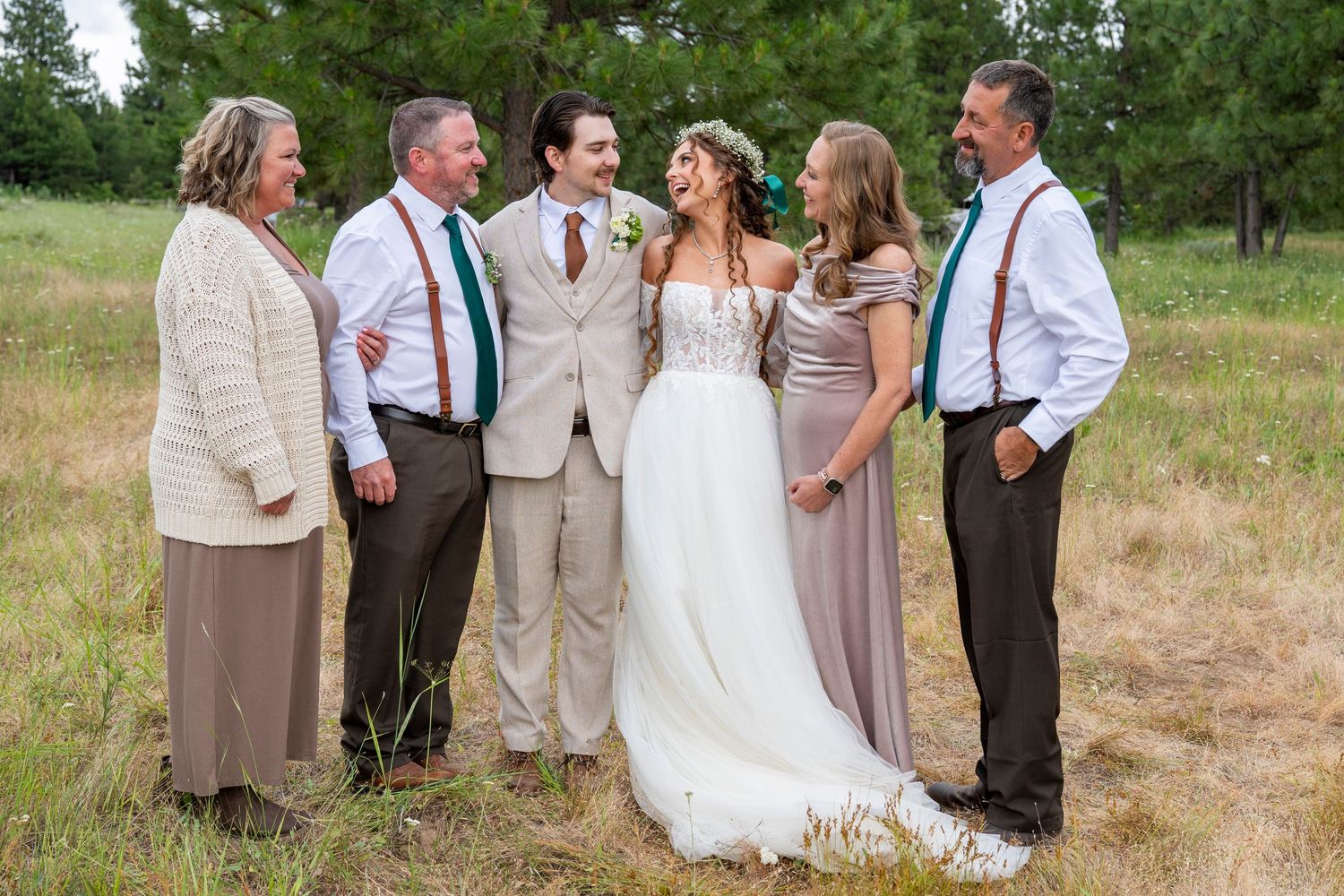 Groom and family smile at bride at wedding in the dalles, oregon