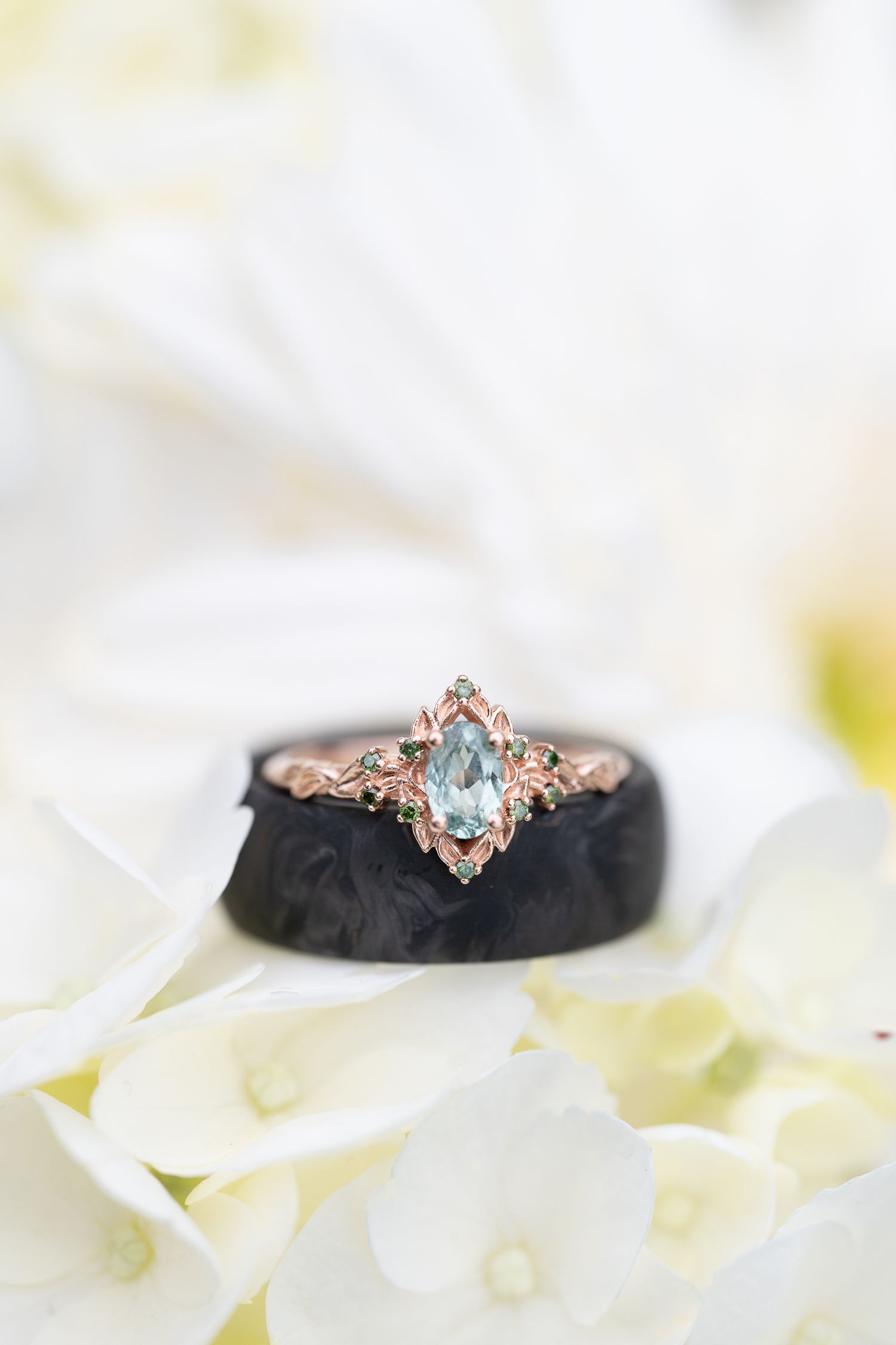 An oregon bride and groom's wedding rings stacked on white flowers
