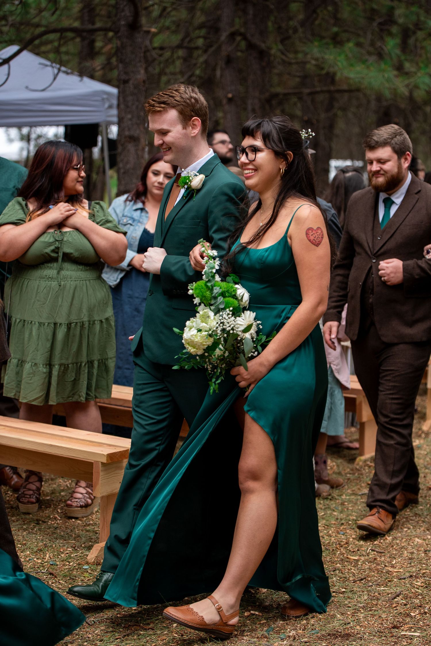 Bridesmaid and bridesman walk down the aisle after an oregon wedding ceremony