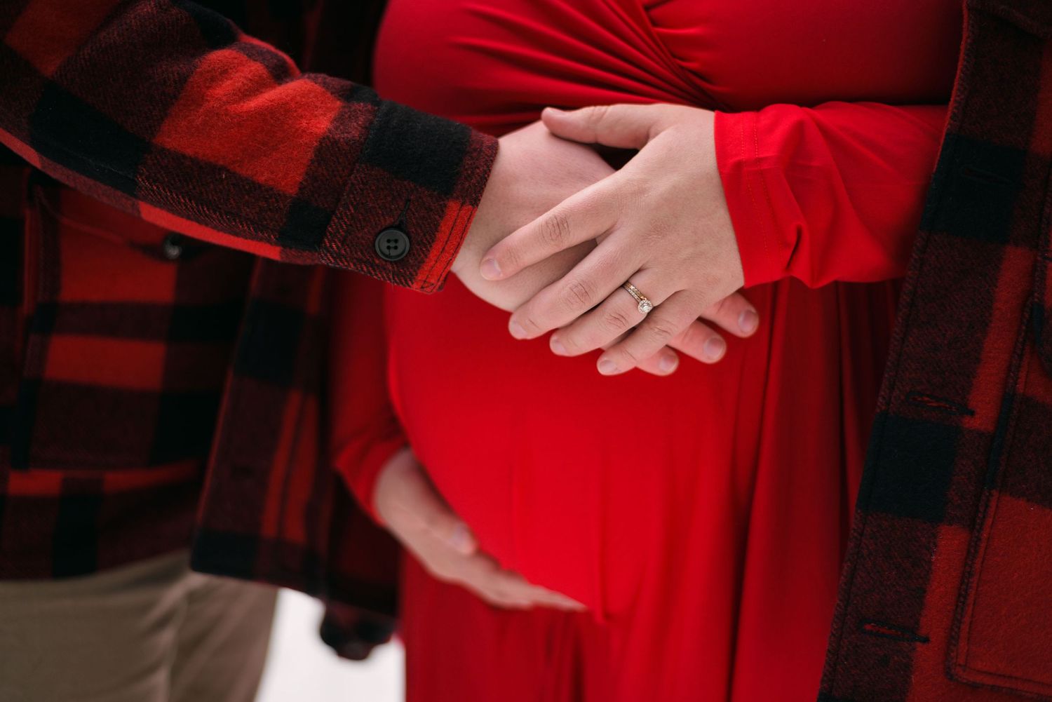 Close-up details of a vibrant red formal dress against dark background.