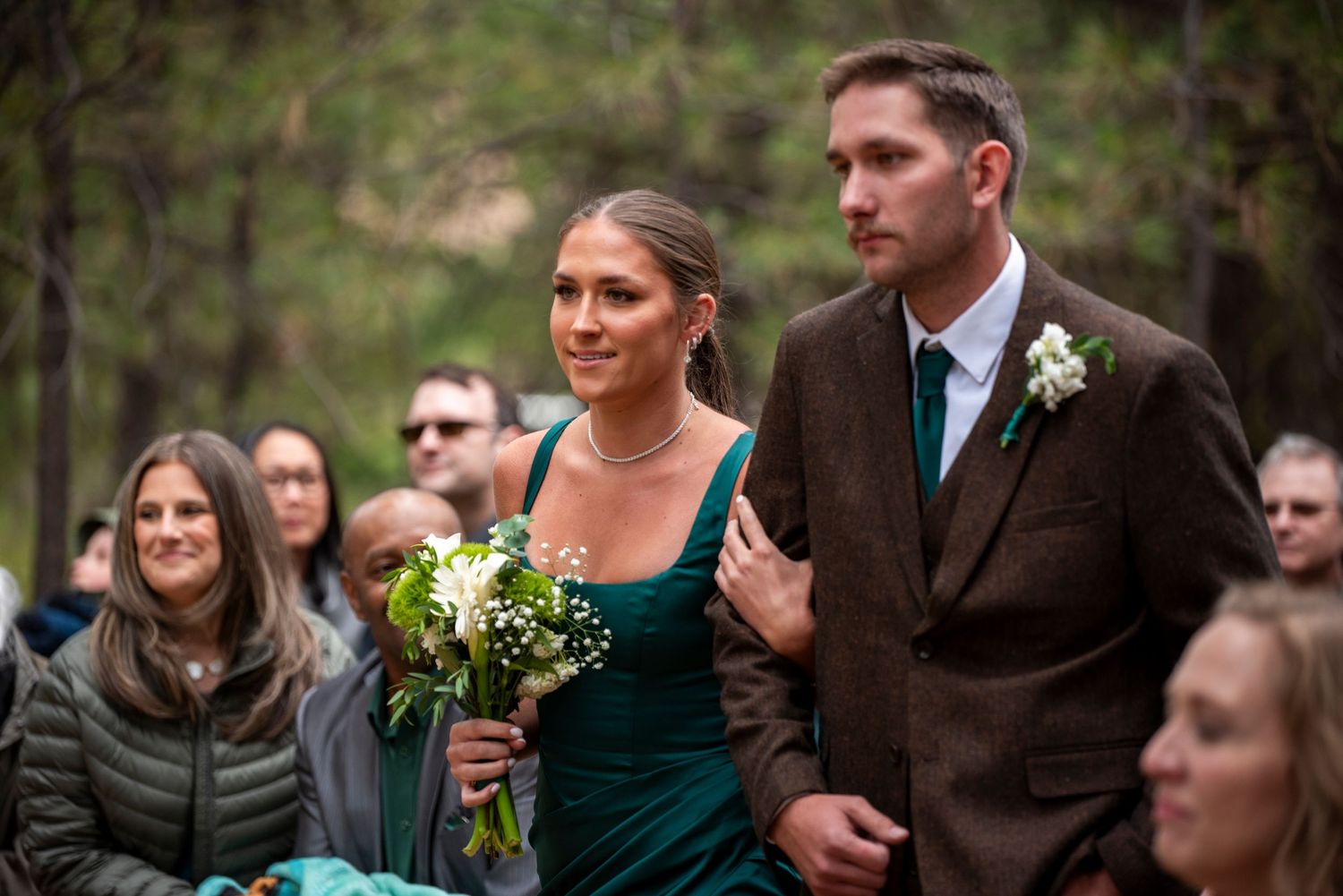 A bridesmaid and groomsmen walk down the aisle at a wedding ceremony in the dalles, oregon