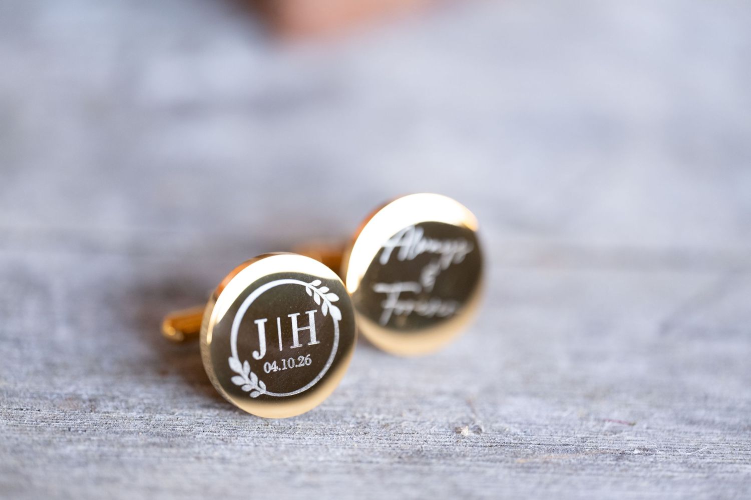 Gold personalized cufflinks with monogram JH, date 04.10.20, floral wreath, and cursive Always Forever engraving.