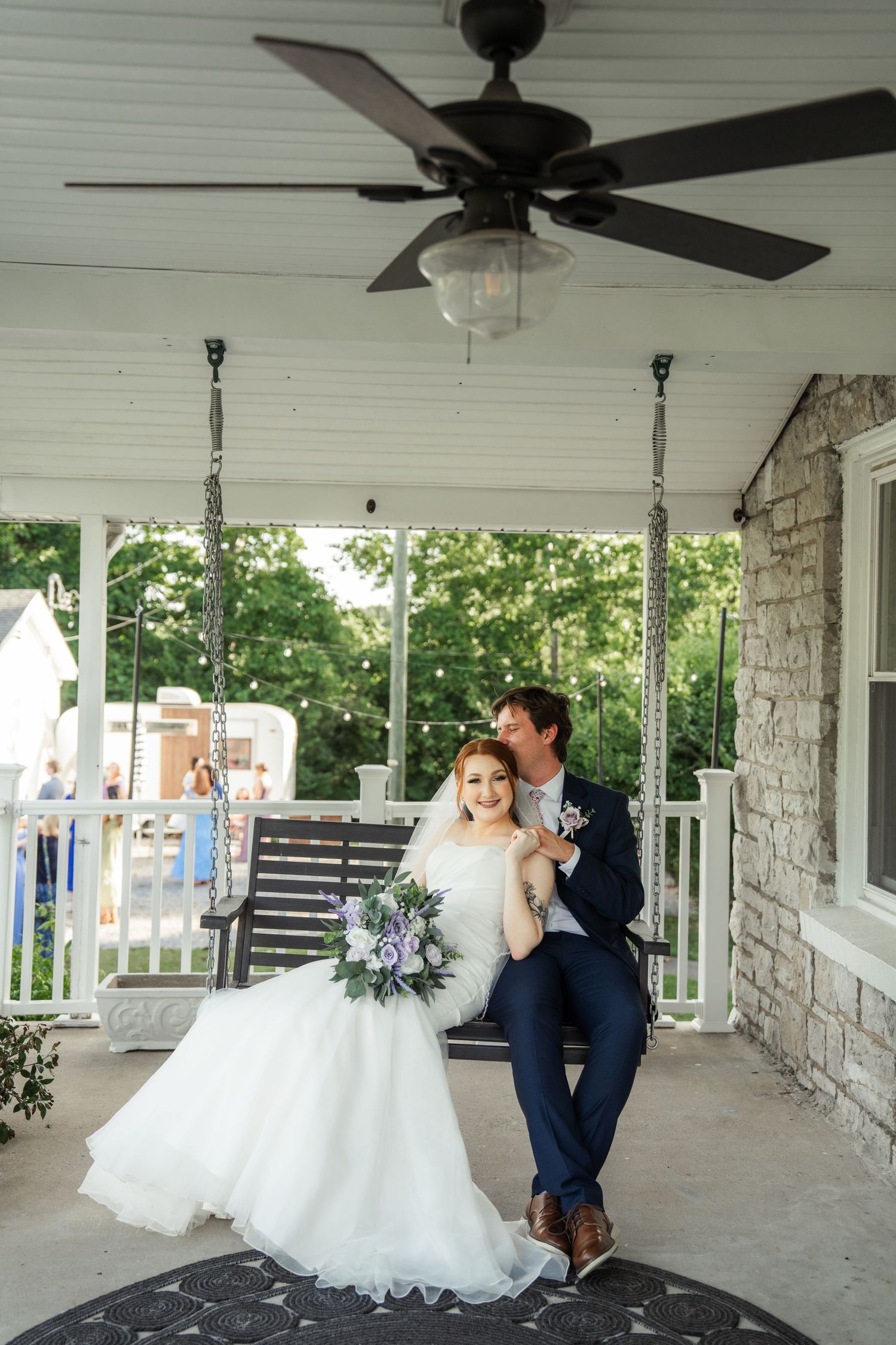 Romantic wedding photo series showing couple embracing on a covered stone porch at micro wedding in Nashville.