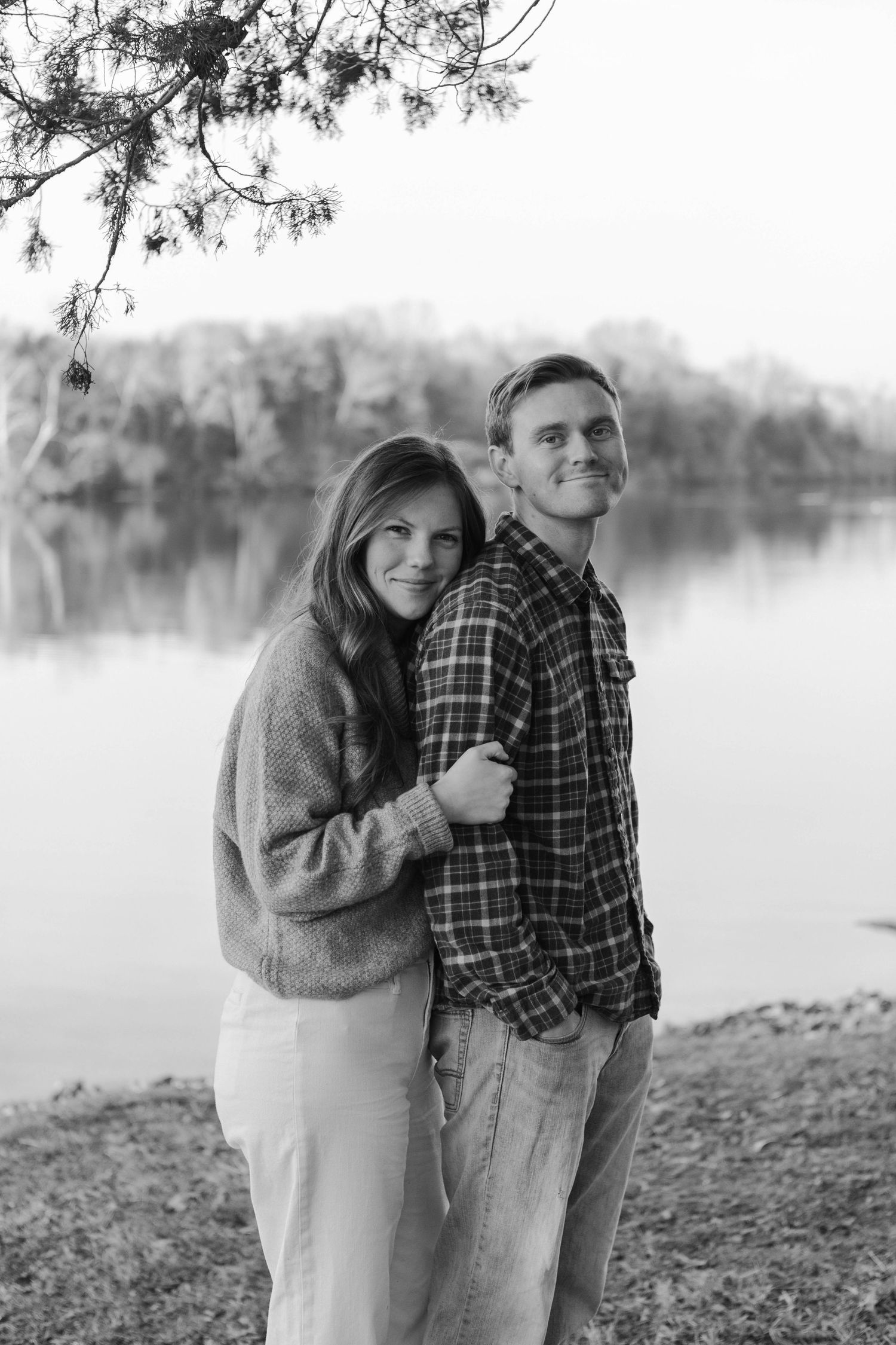 Couple embracing by a lake in a classic black and white portrait photograph in Nashville.