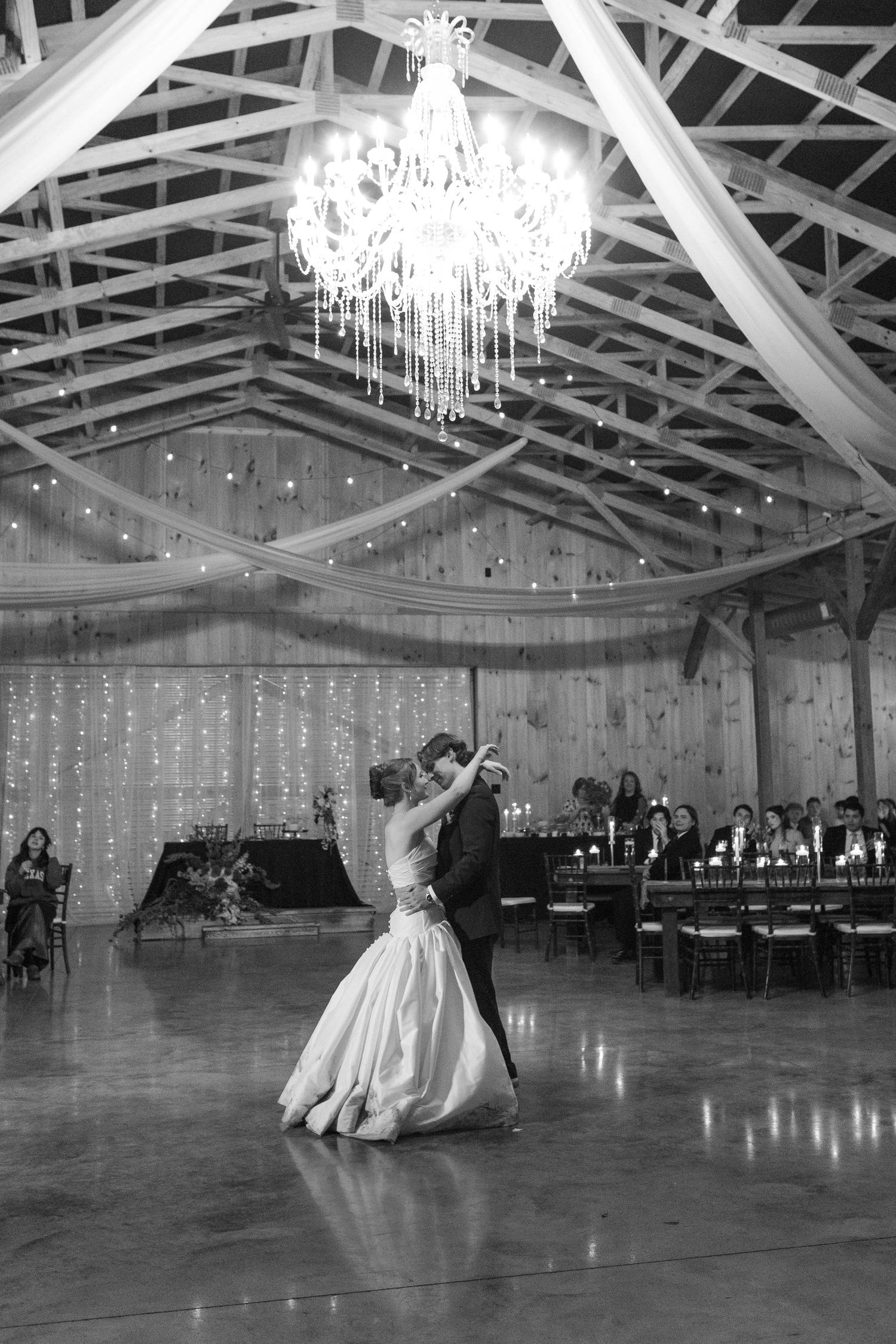 Bride and groom share first dance after eloping in Nashville under chandelier in elegant venue.