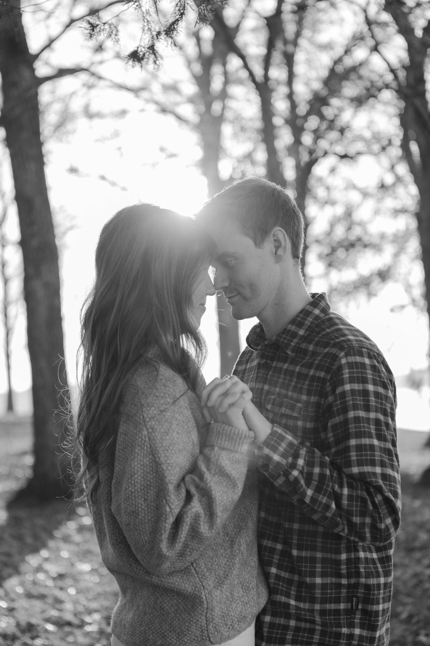 Romantic woods photoshoot with sunlight streaming through trees in black and white in Nashville.
