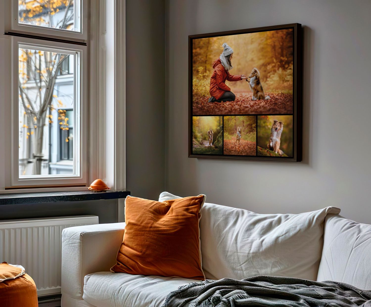 Framed autumn photo collage of woman with her dog on wall above white sofa with orange cushions.