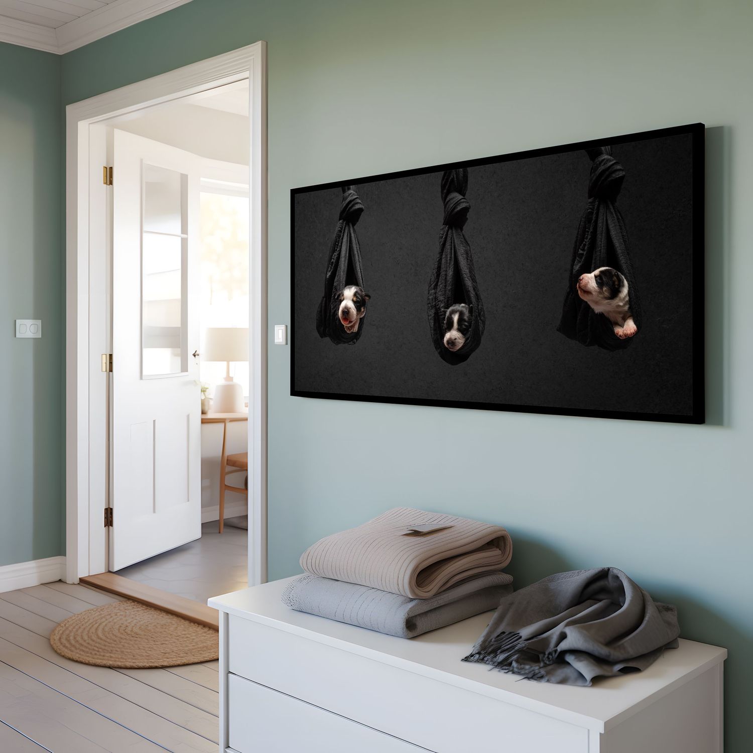 3 border collie puppies hanging in fabric knots on a dark canvas wall art.
