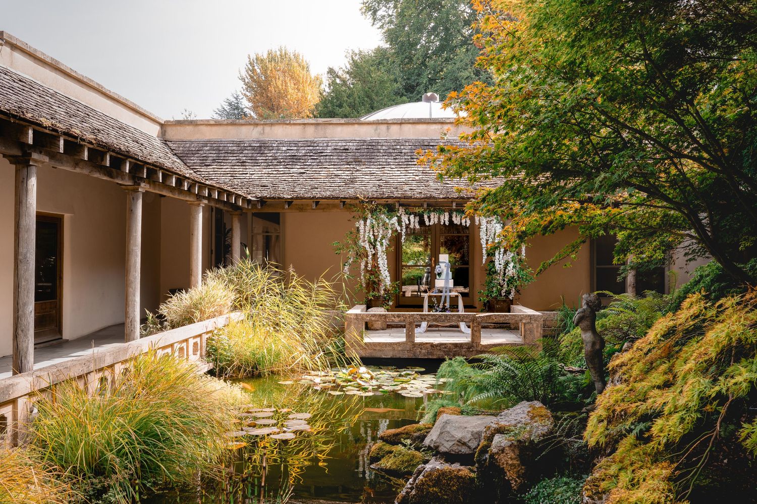Scenic autumn wedding venue with stone architecture and fall foliage.
