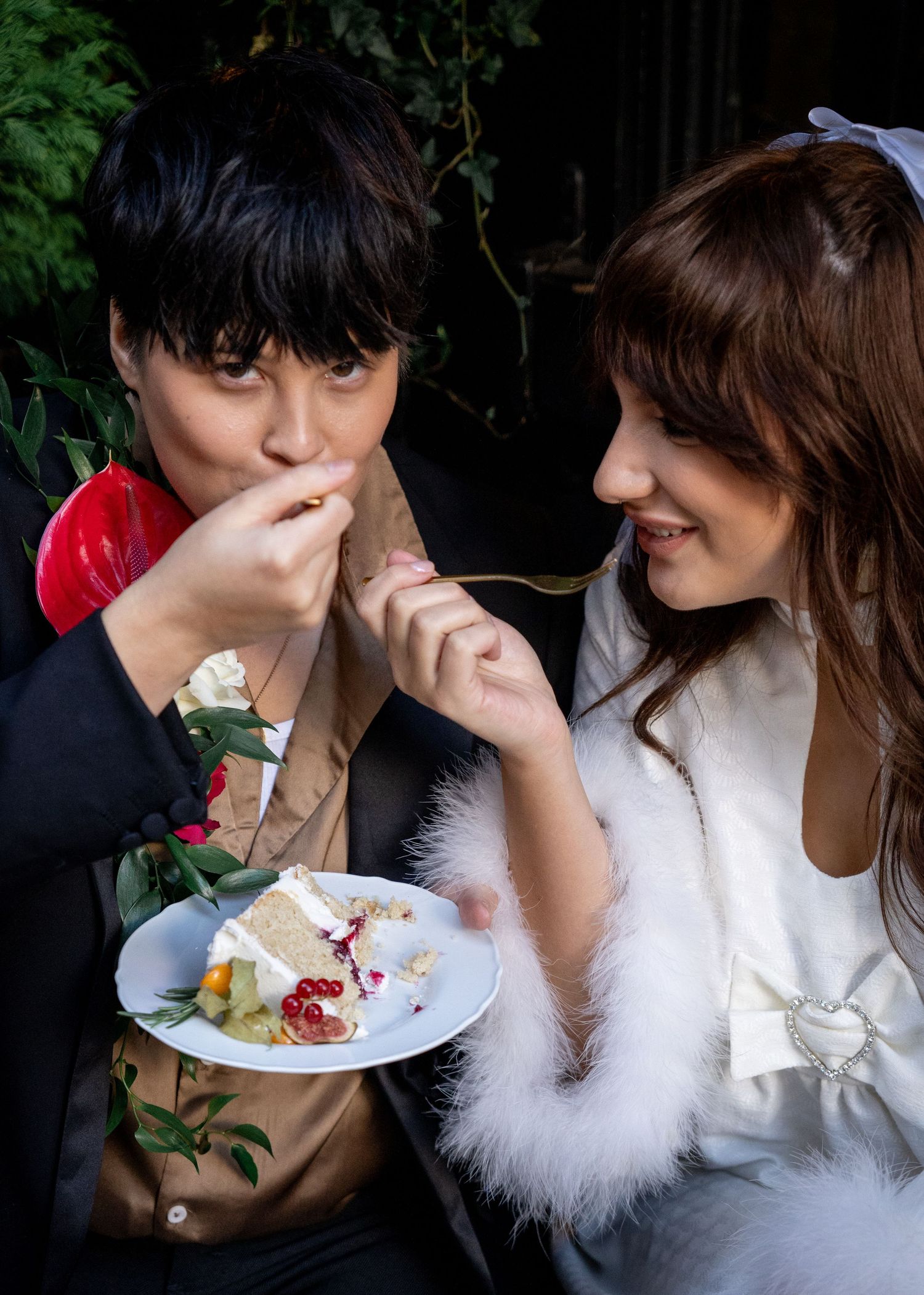 Couple sharing cake and romantic moments during wedding reception.