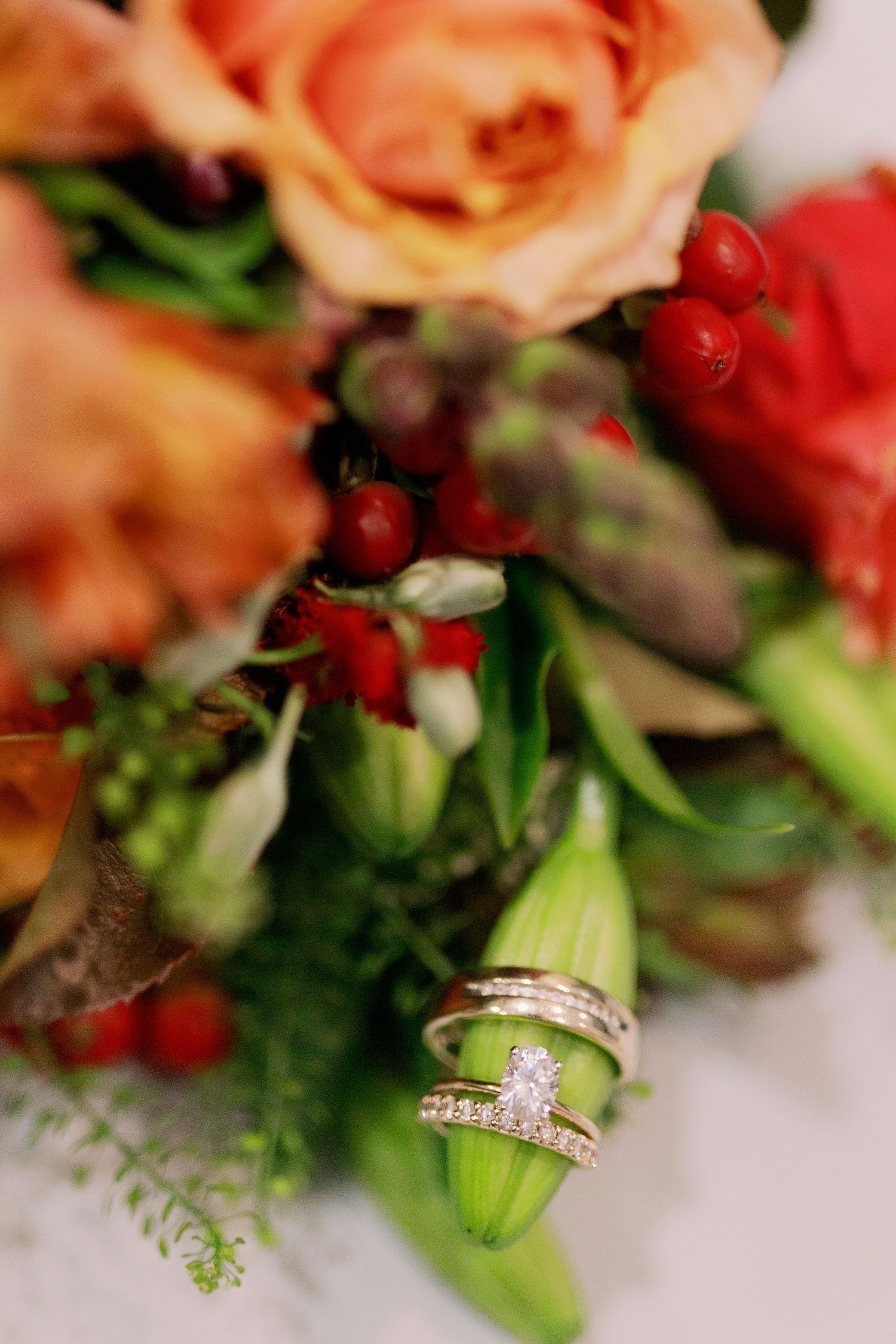 Close up of rings on bridal bouquet