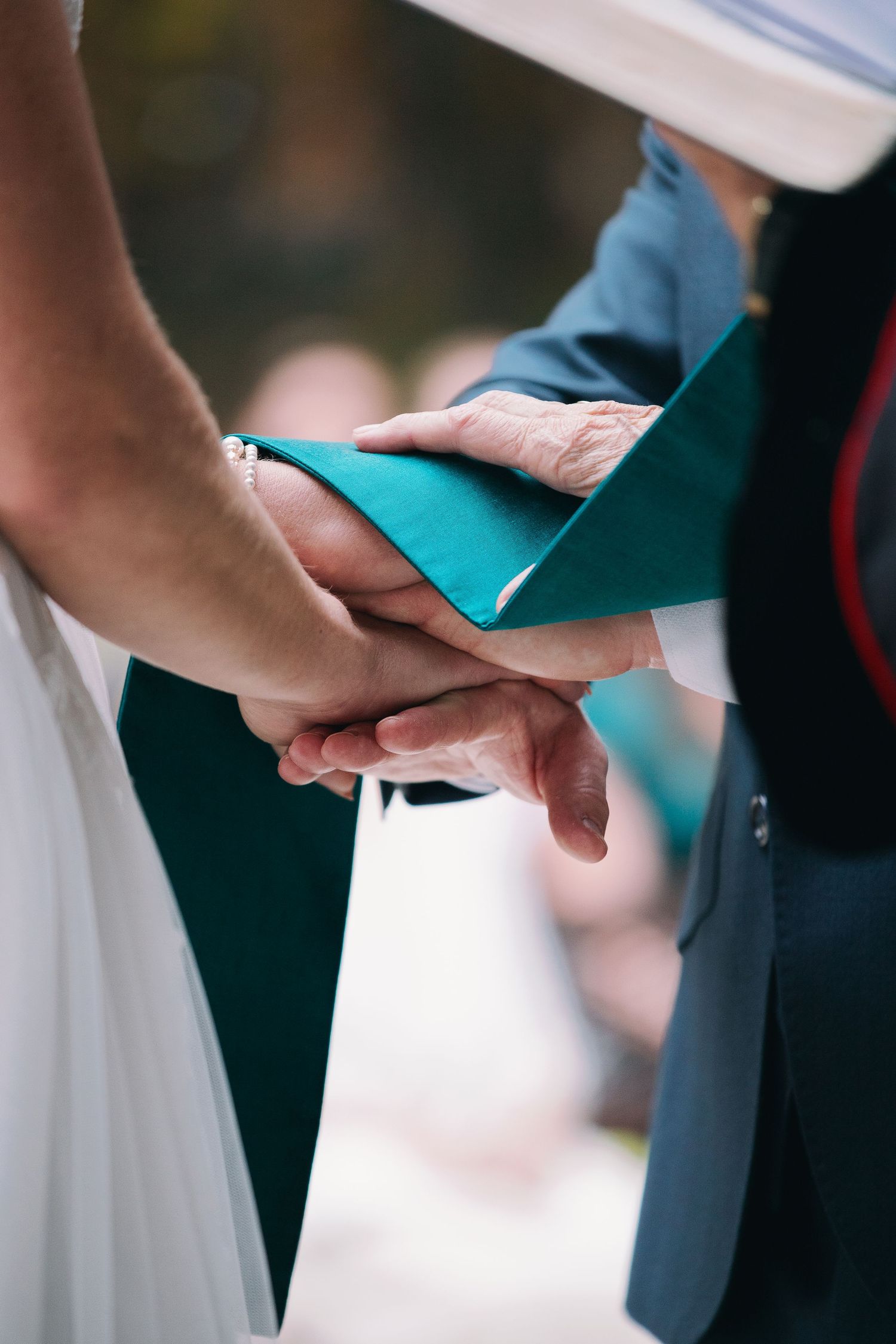 Hands and prayer cloth during wedding ceremony
