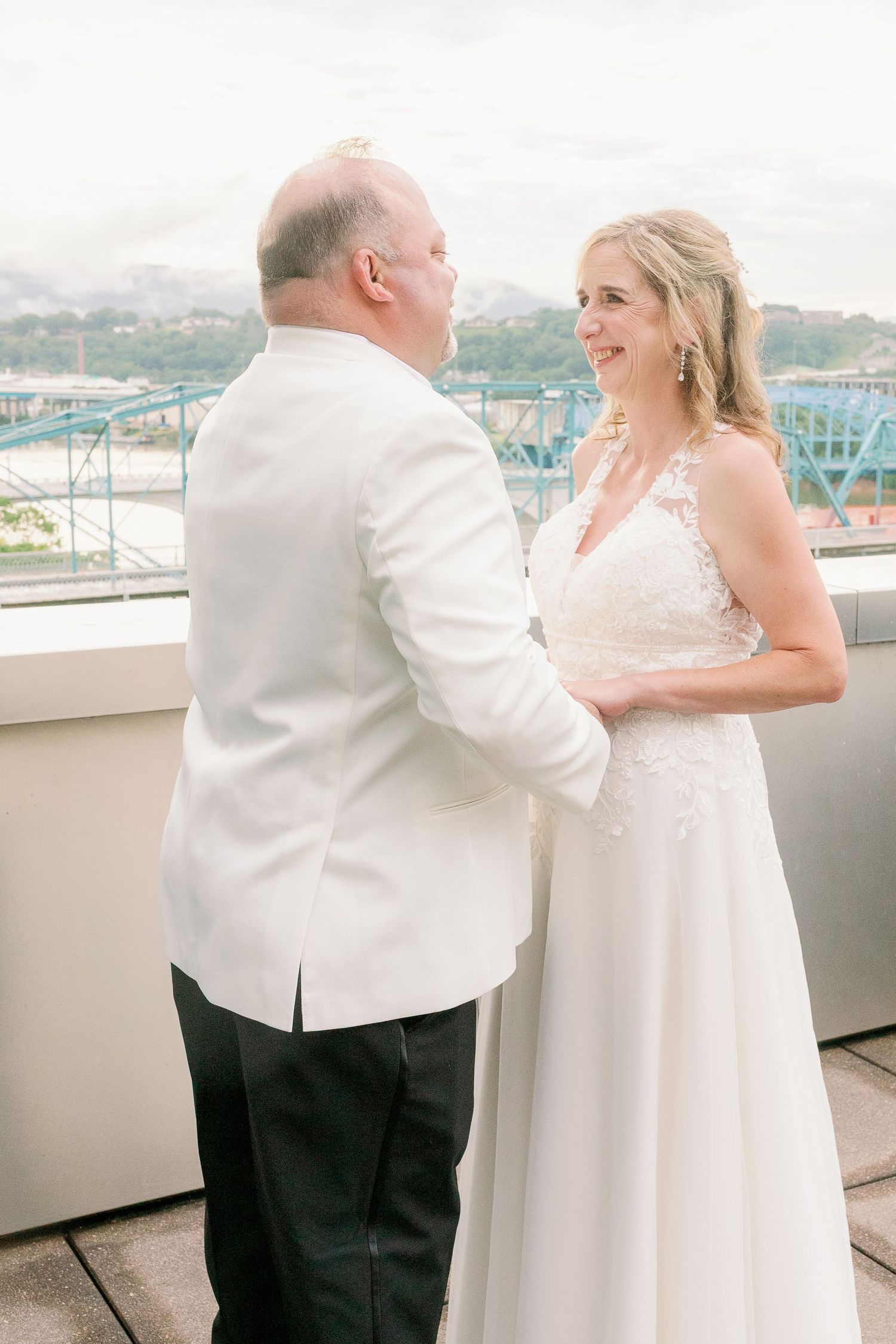 bride and groom hold hands for photo