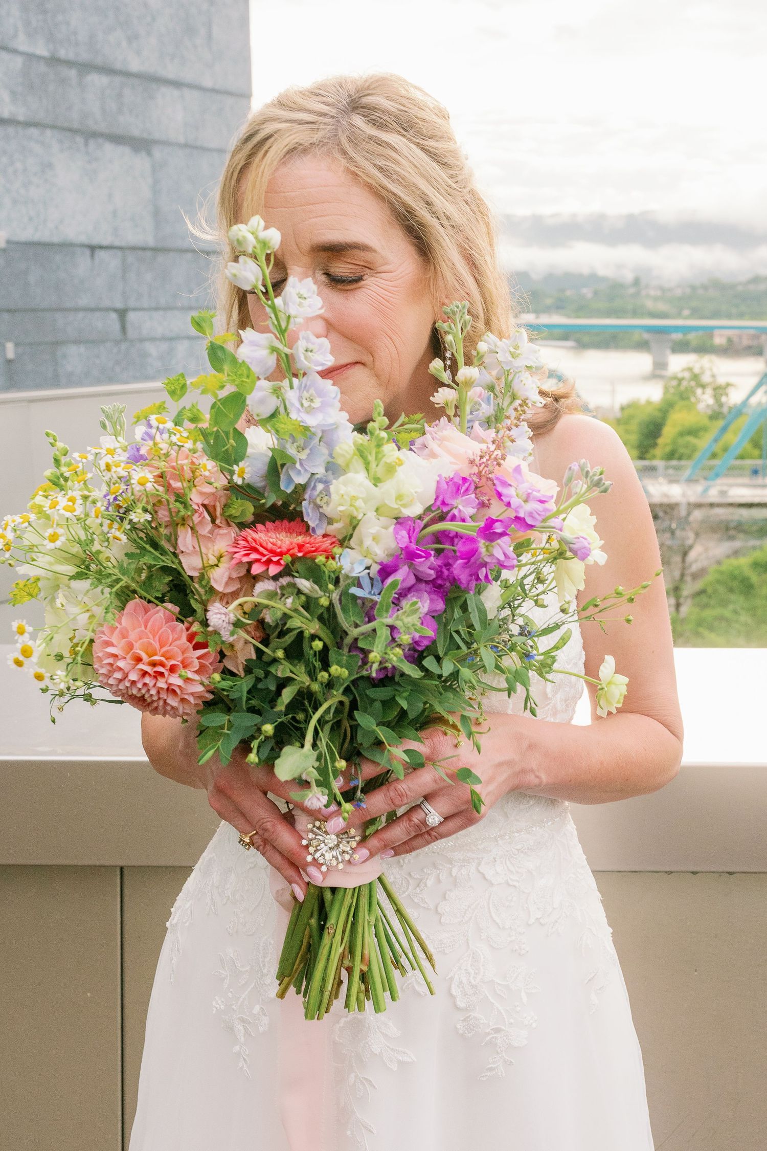 Bride smells flowers up close