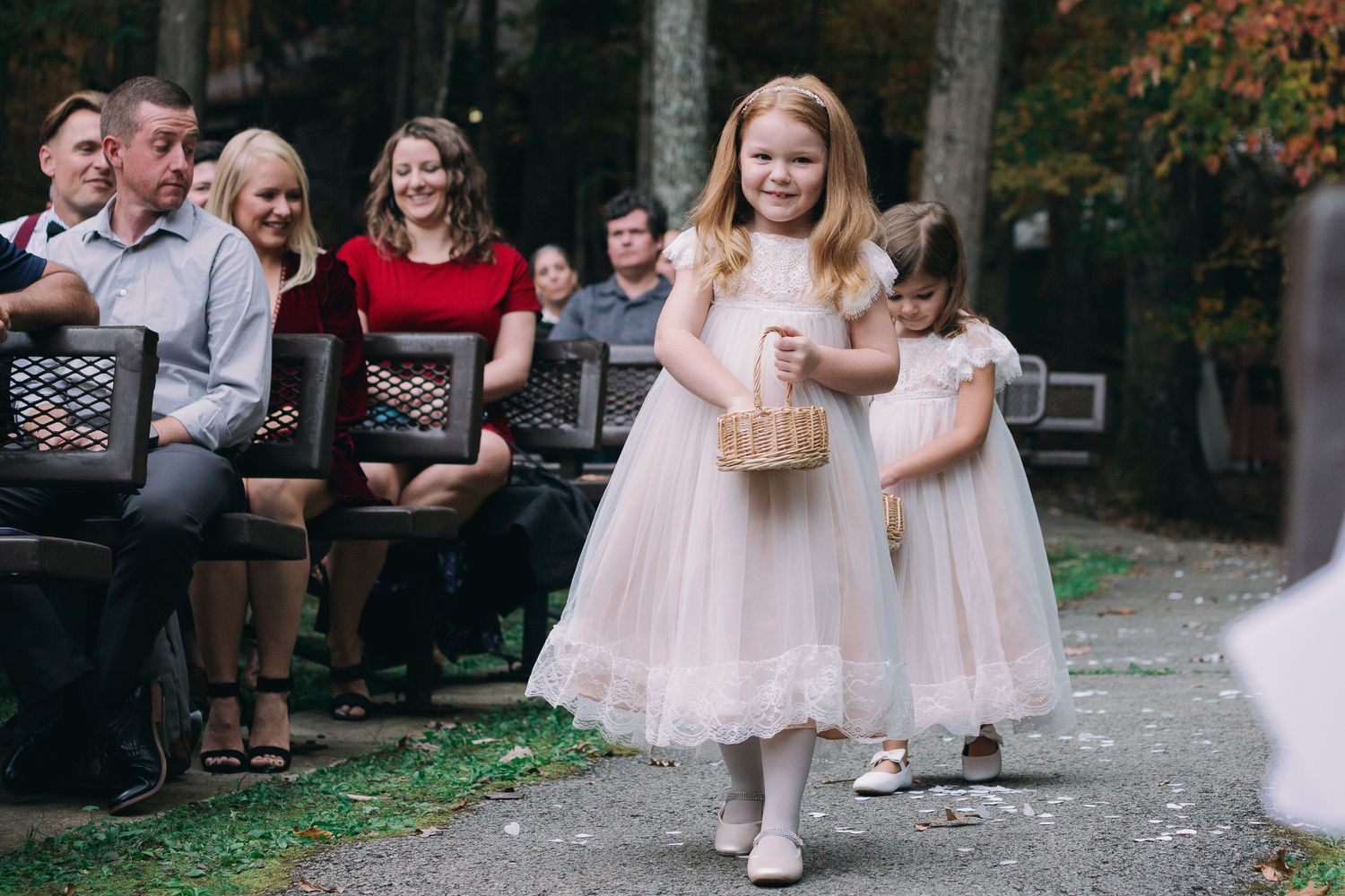 flower girl walking down aisle throwing flowers